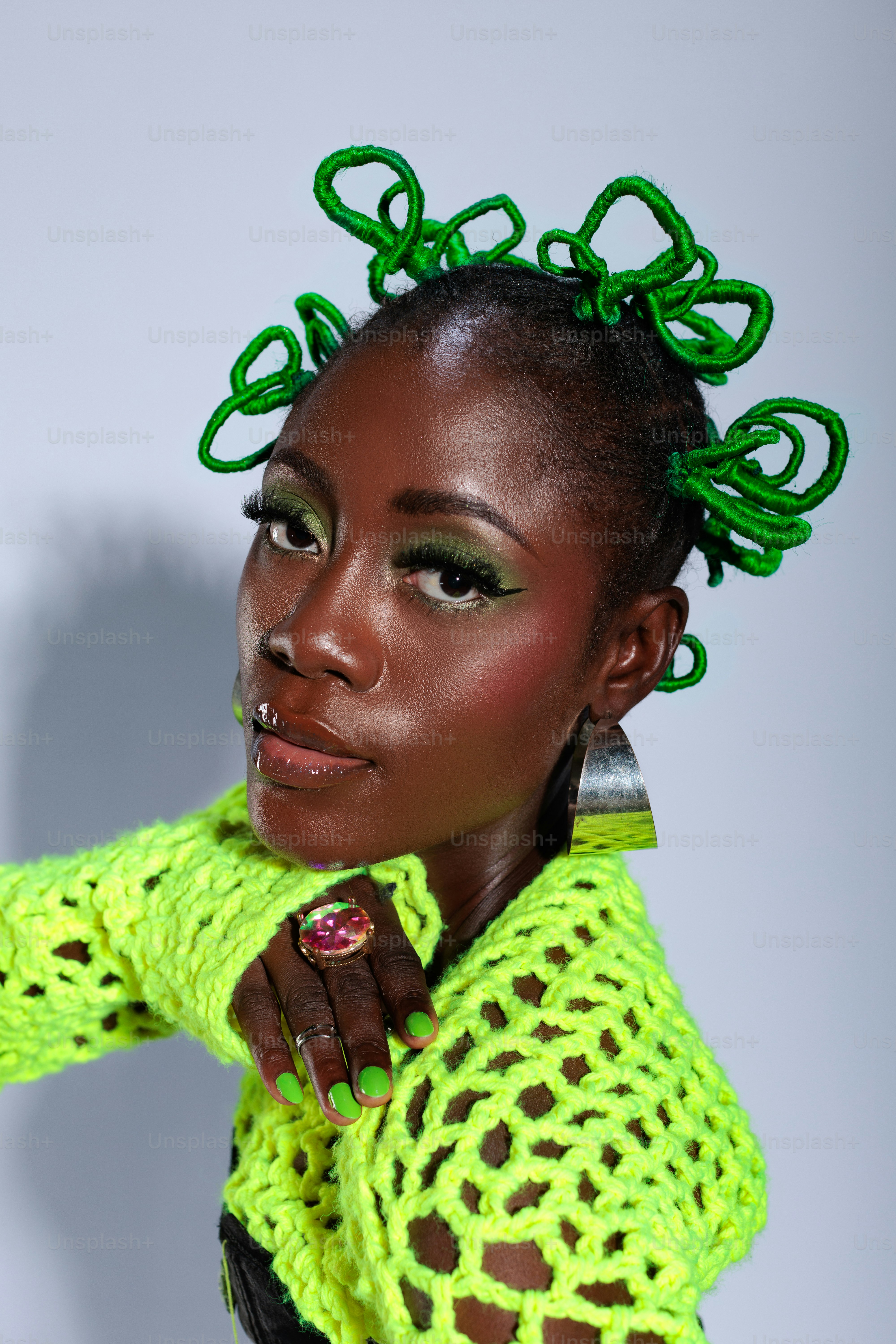 A woman with green hair is posing for a picture