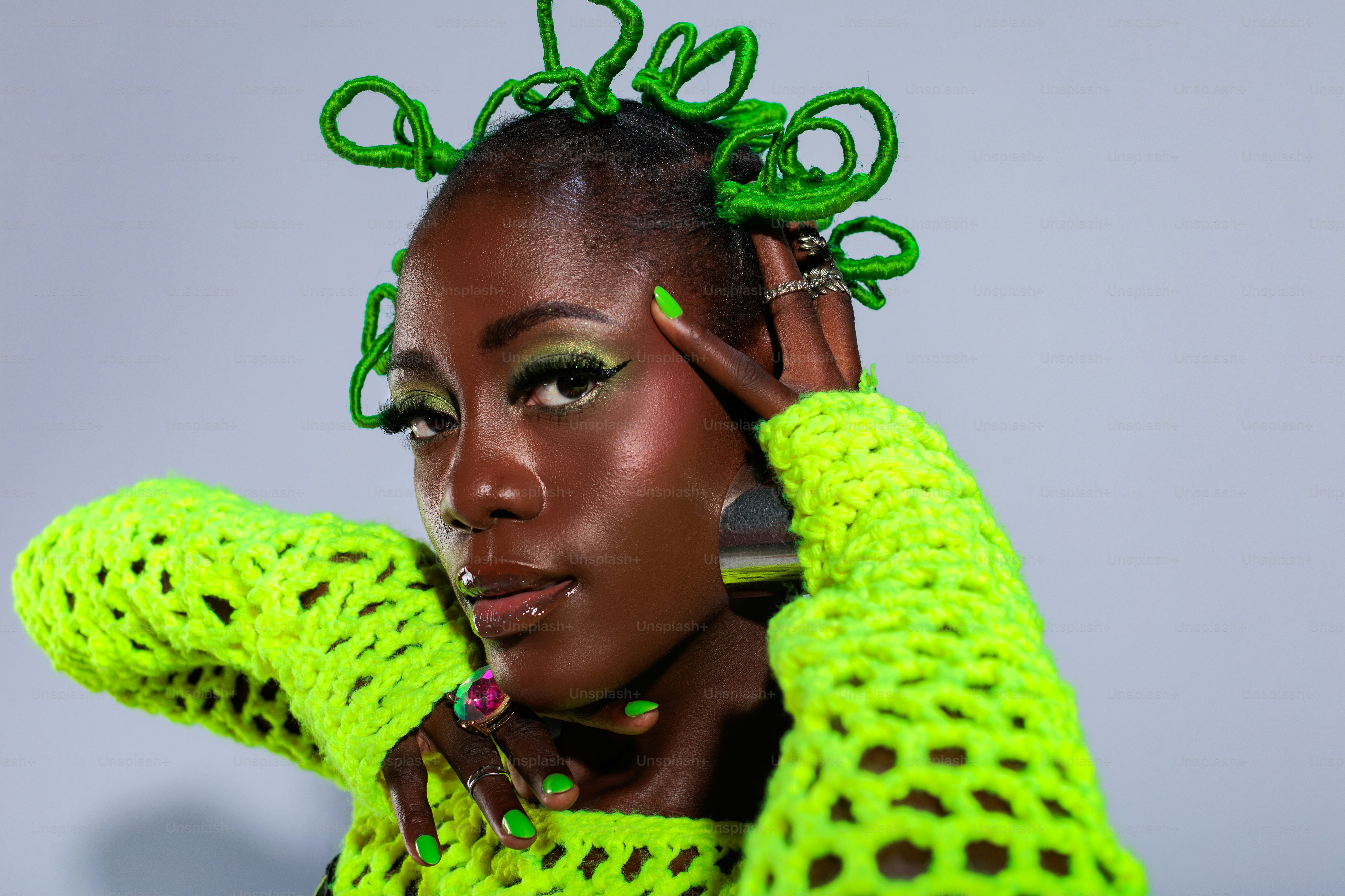 A woman with green hair is posing for a picture