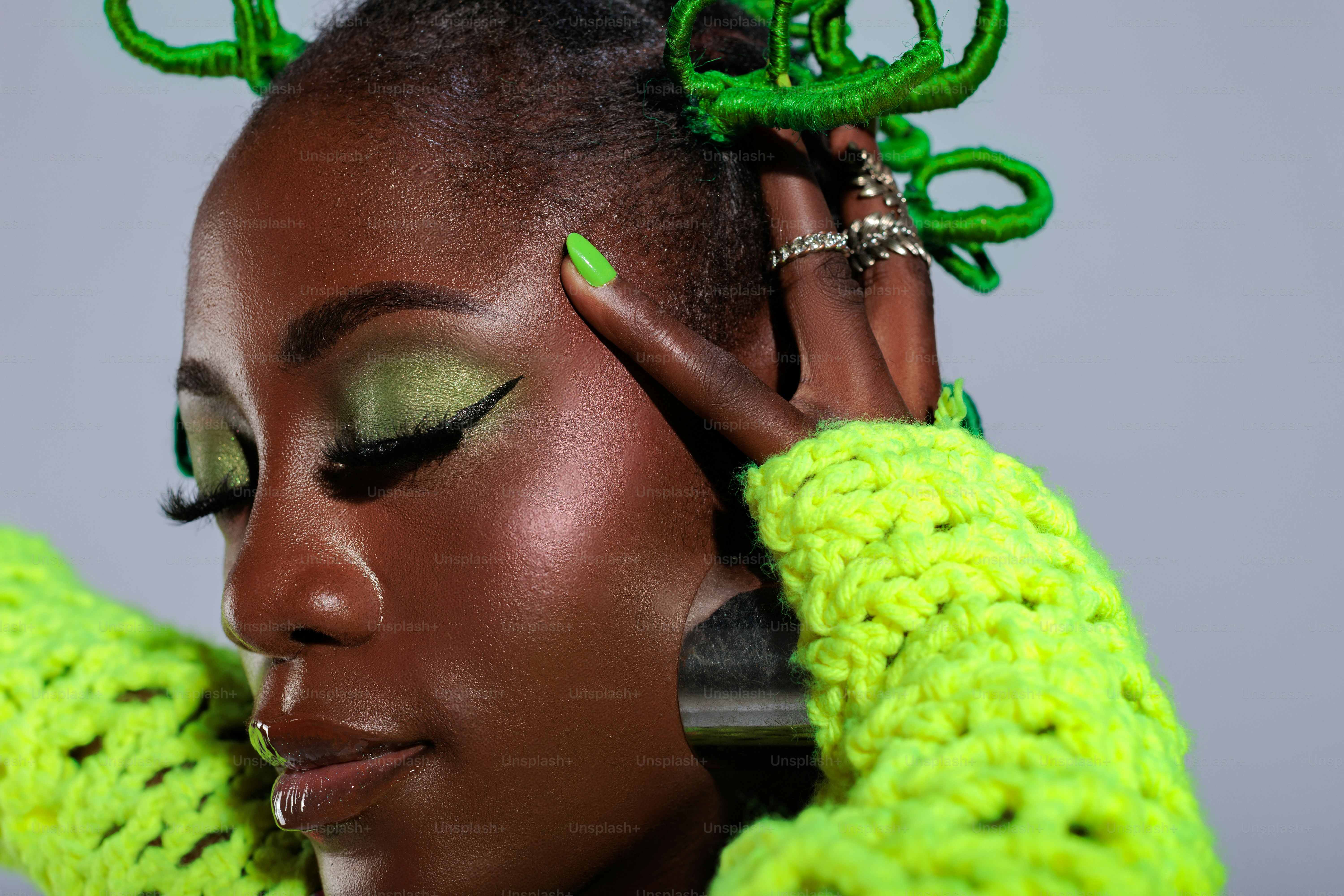 A woman with green hair and green gloves