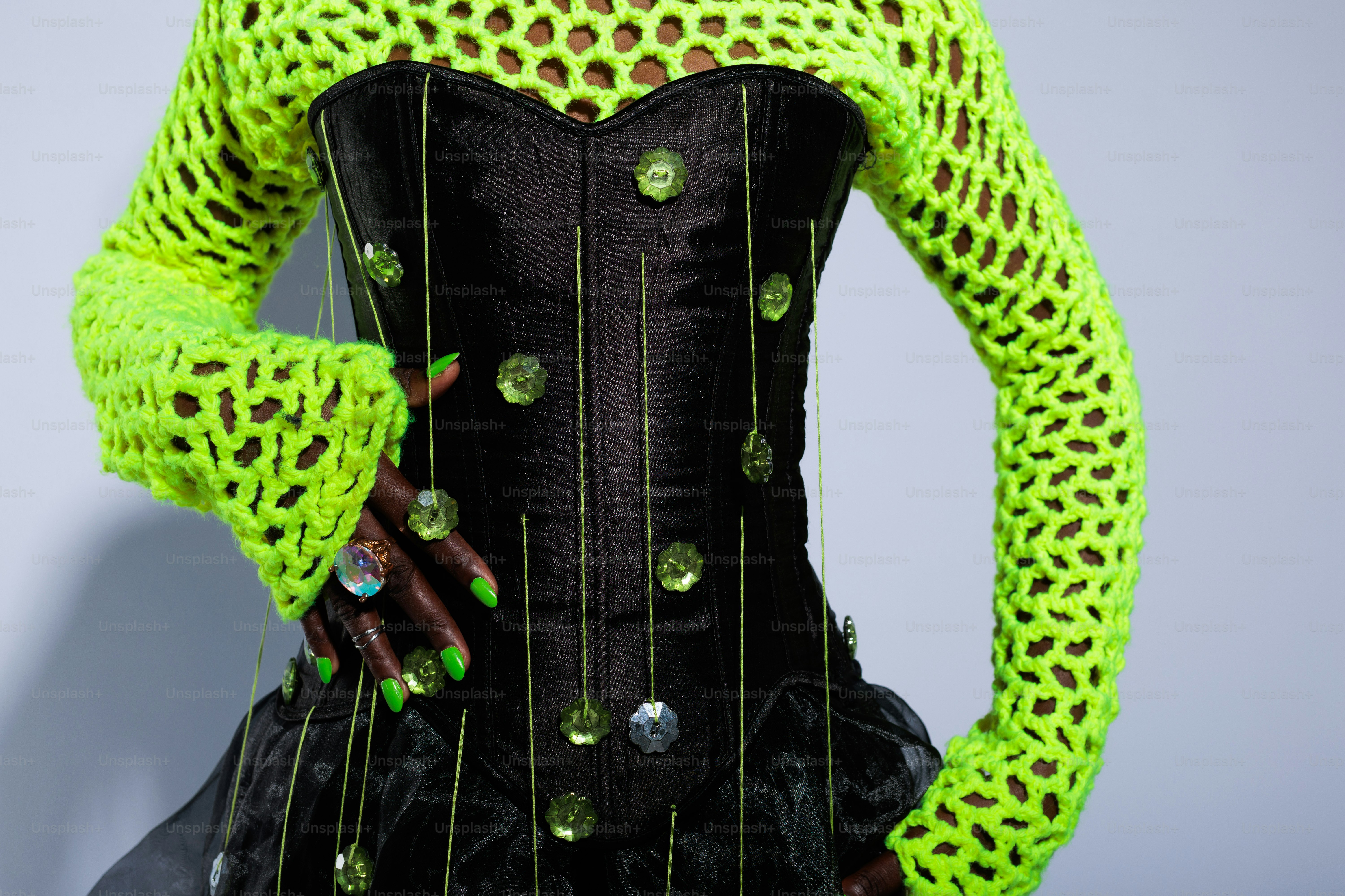 A woman wearing a green and black corset