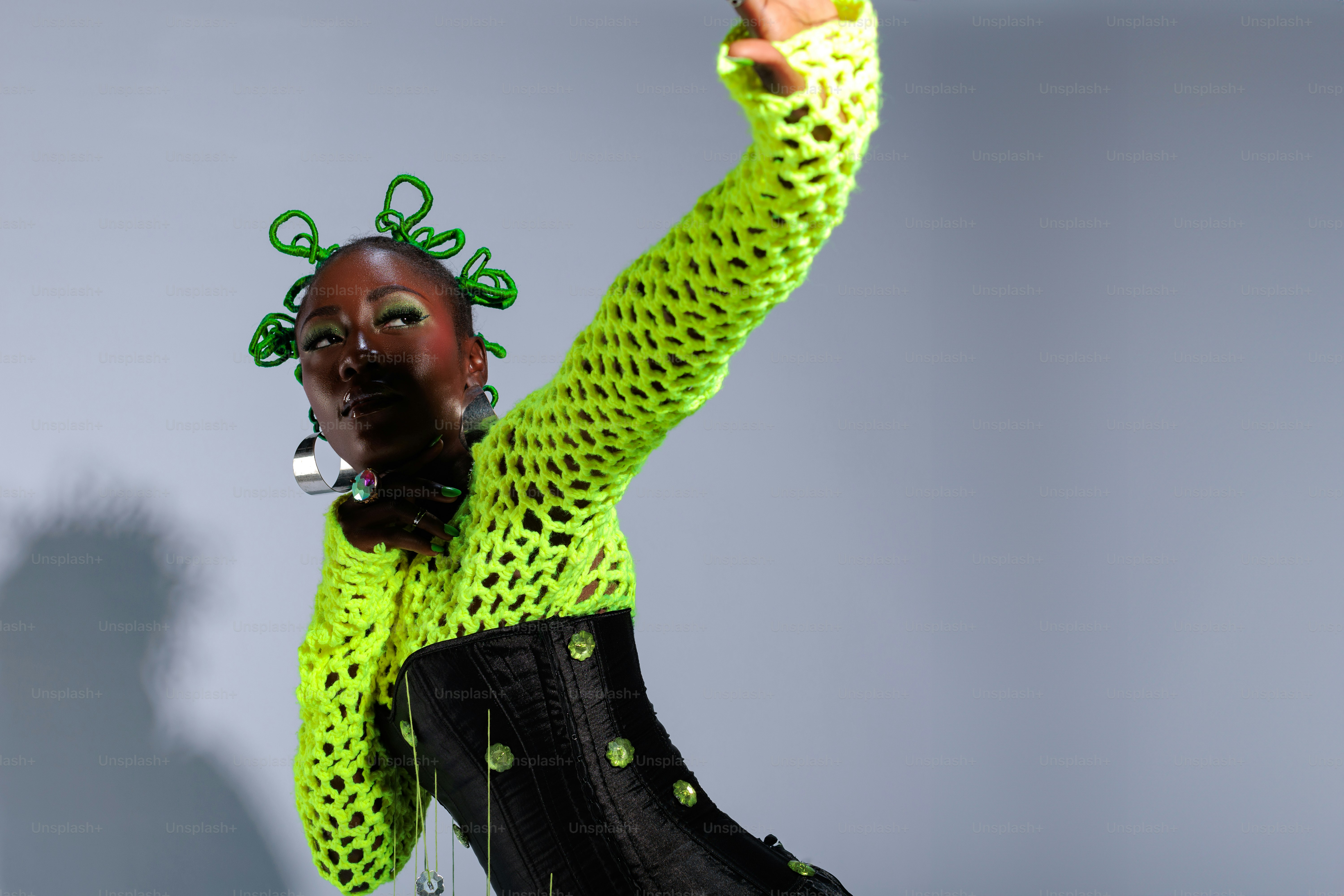 A woman in a green shirt and black pants