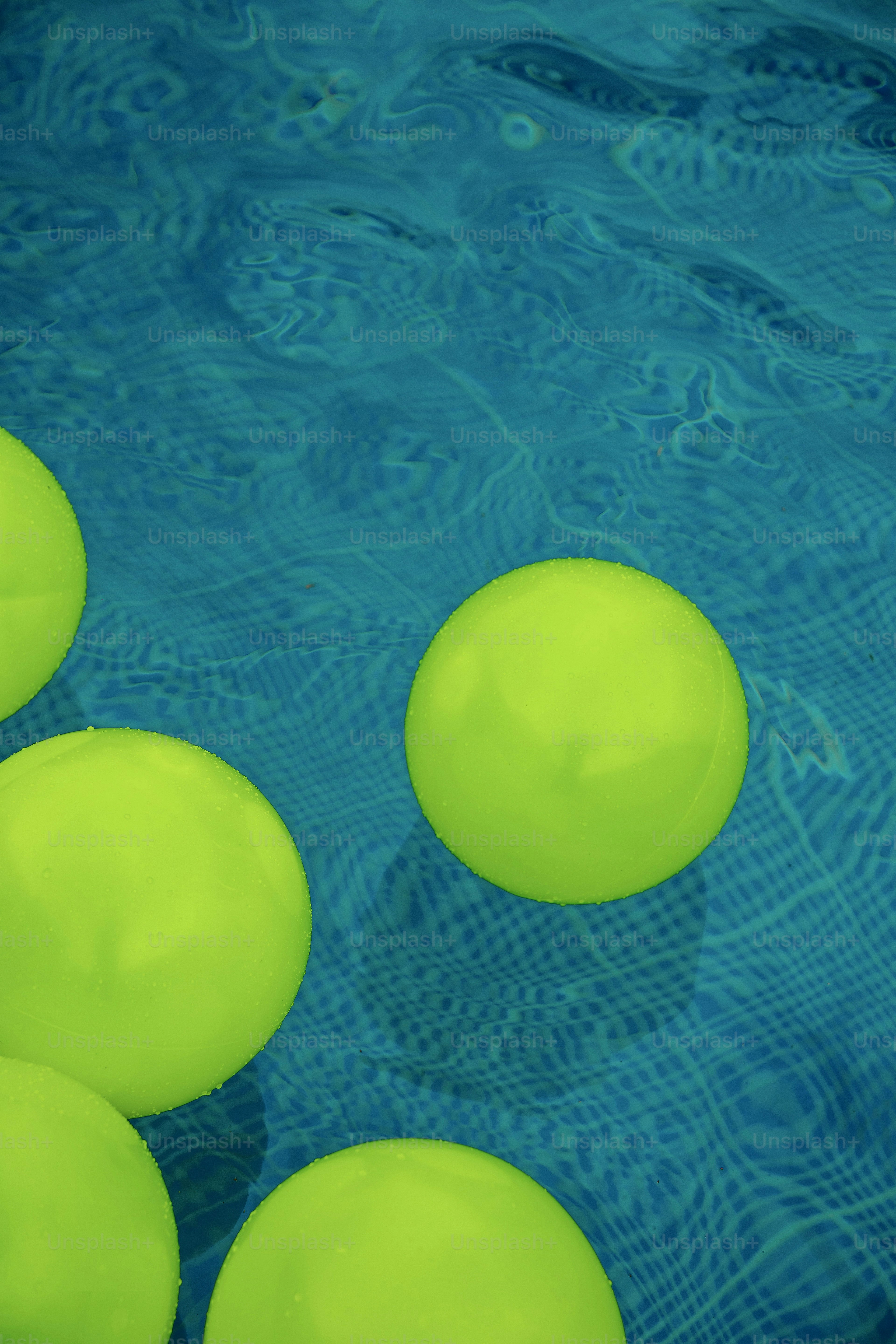A group of green balls floating in a pool