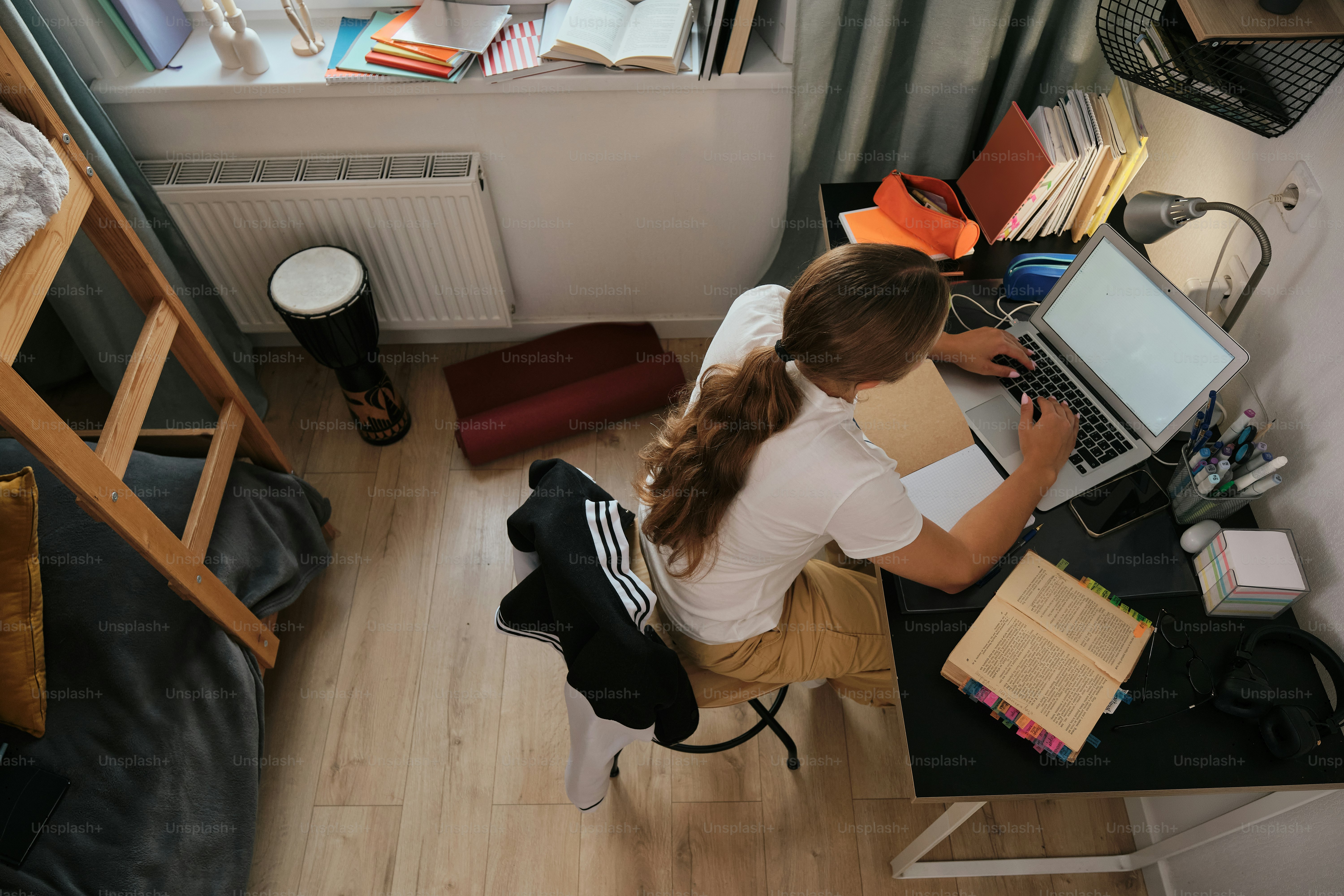 A person sitting at a desk working on a computer