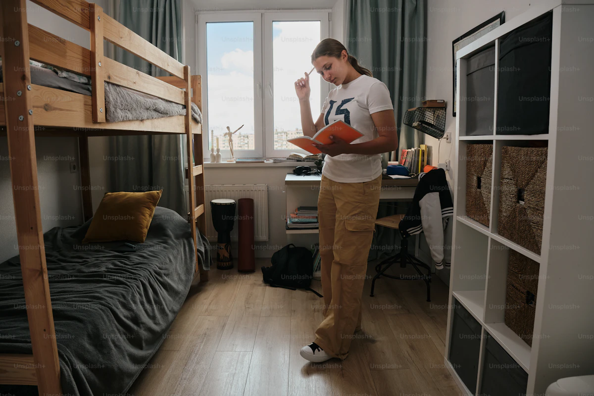 Traveller standing beside dorm bunk beds