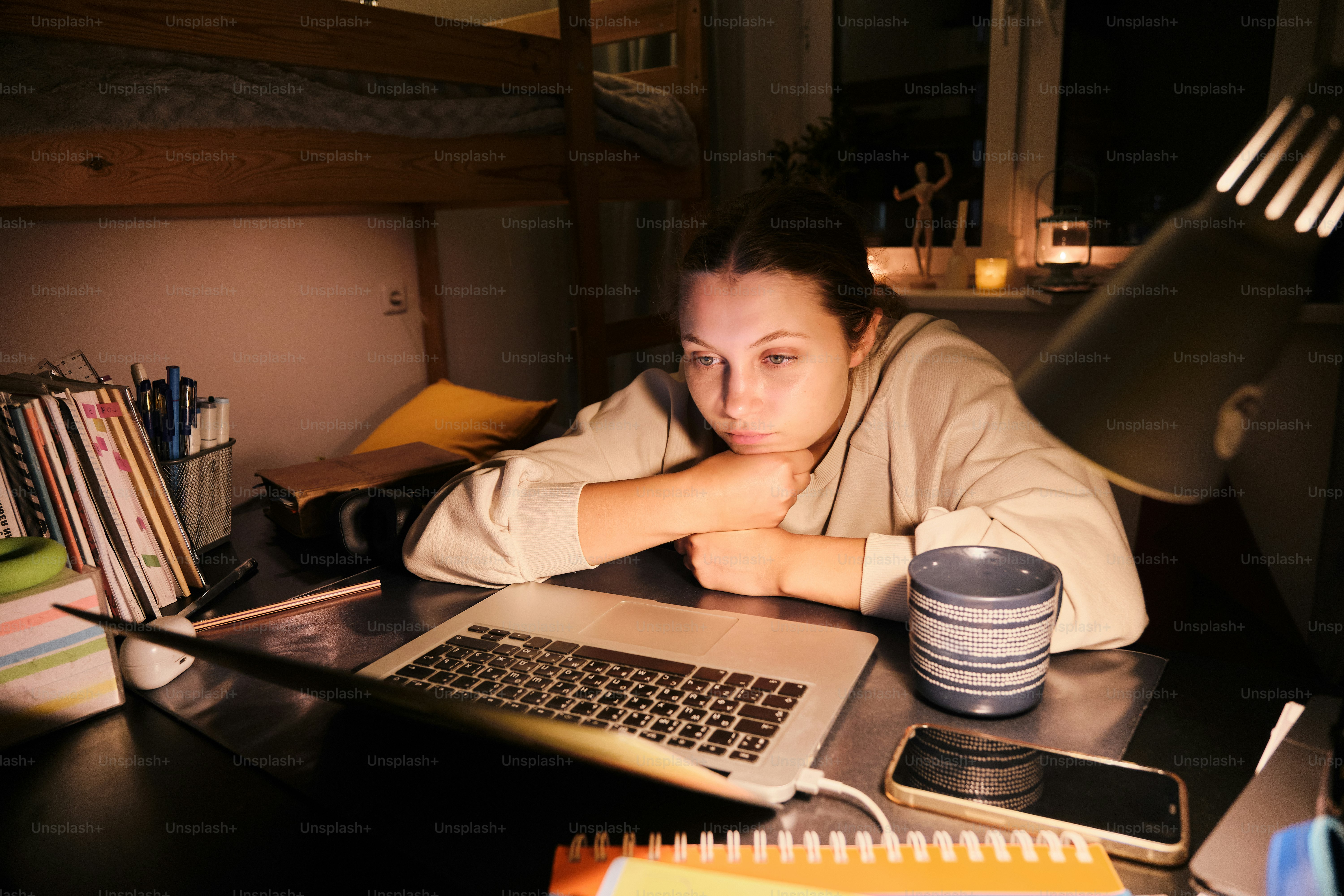 A woman sitting at a desk with a laptop