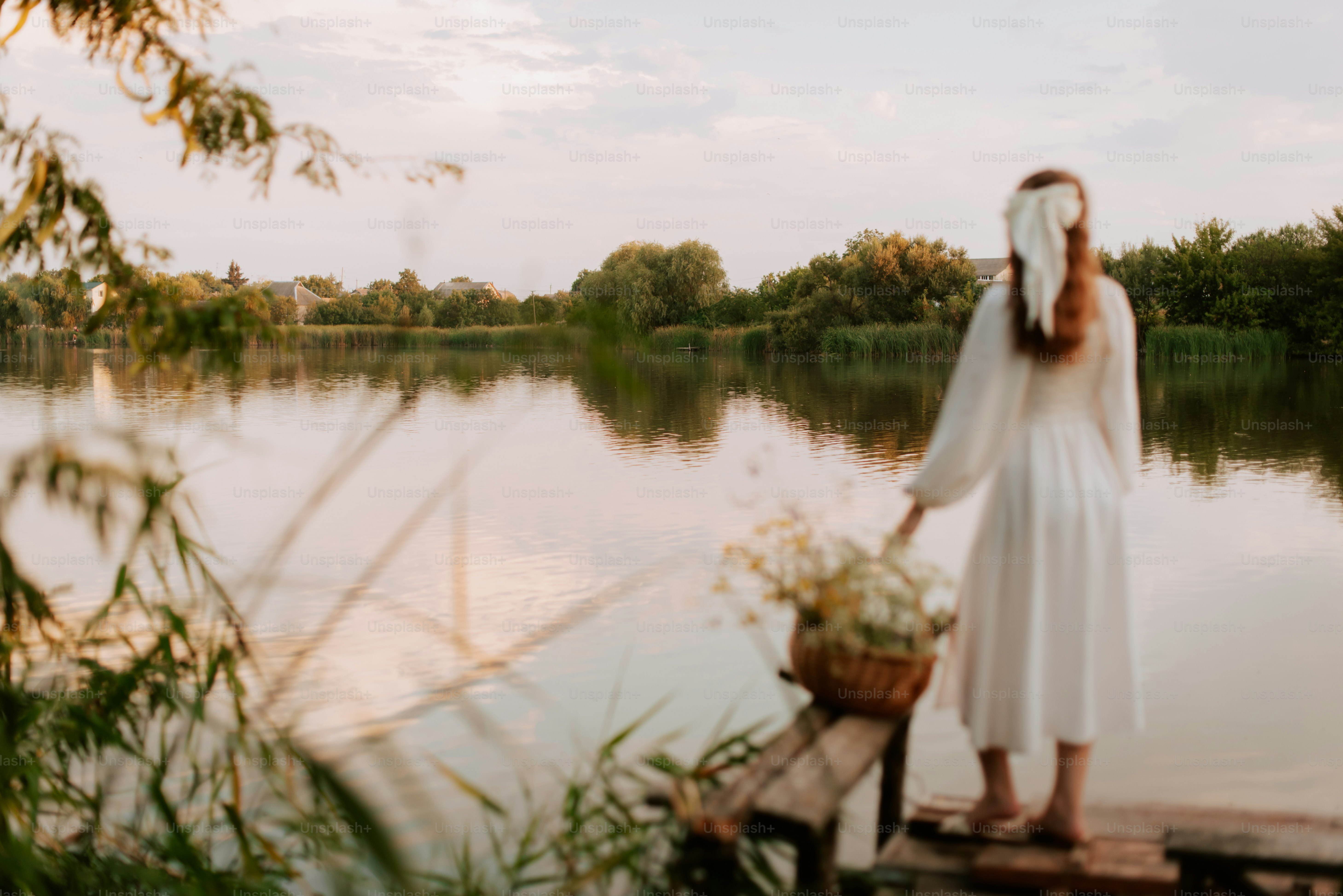 A woman in a white dress standing on a dock