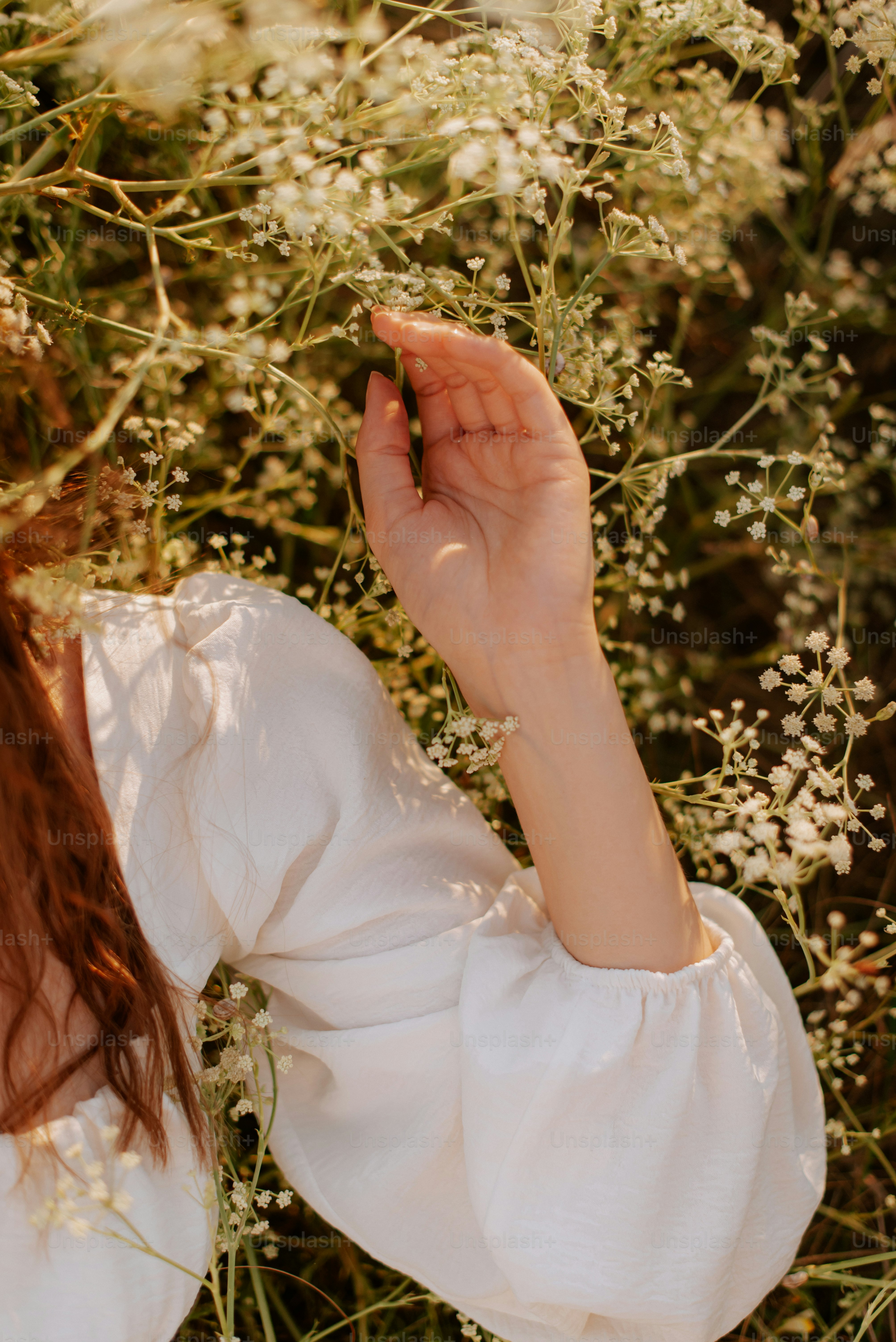 A woman standing in a field of flowers