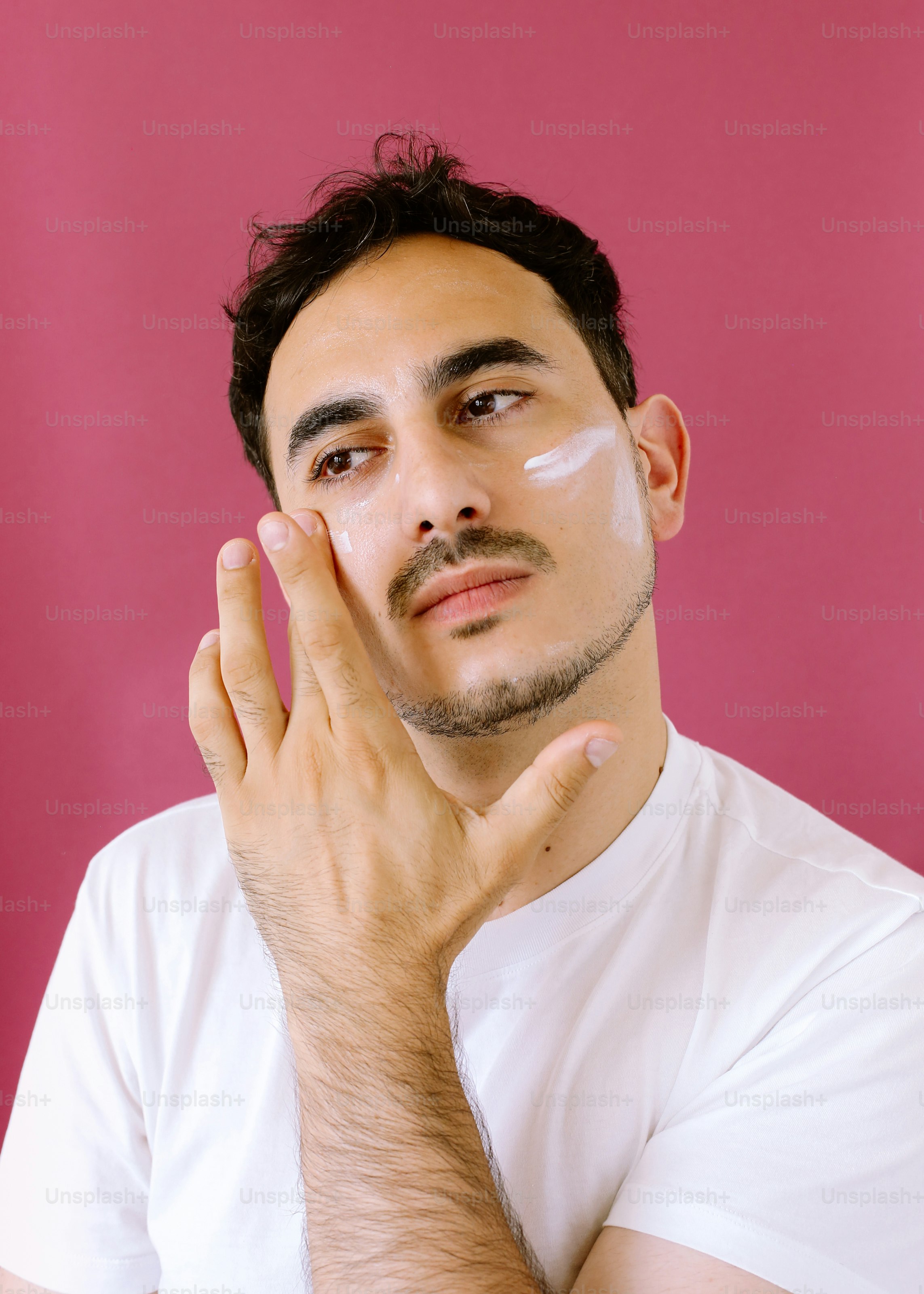 A man holding his hand up to his face