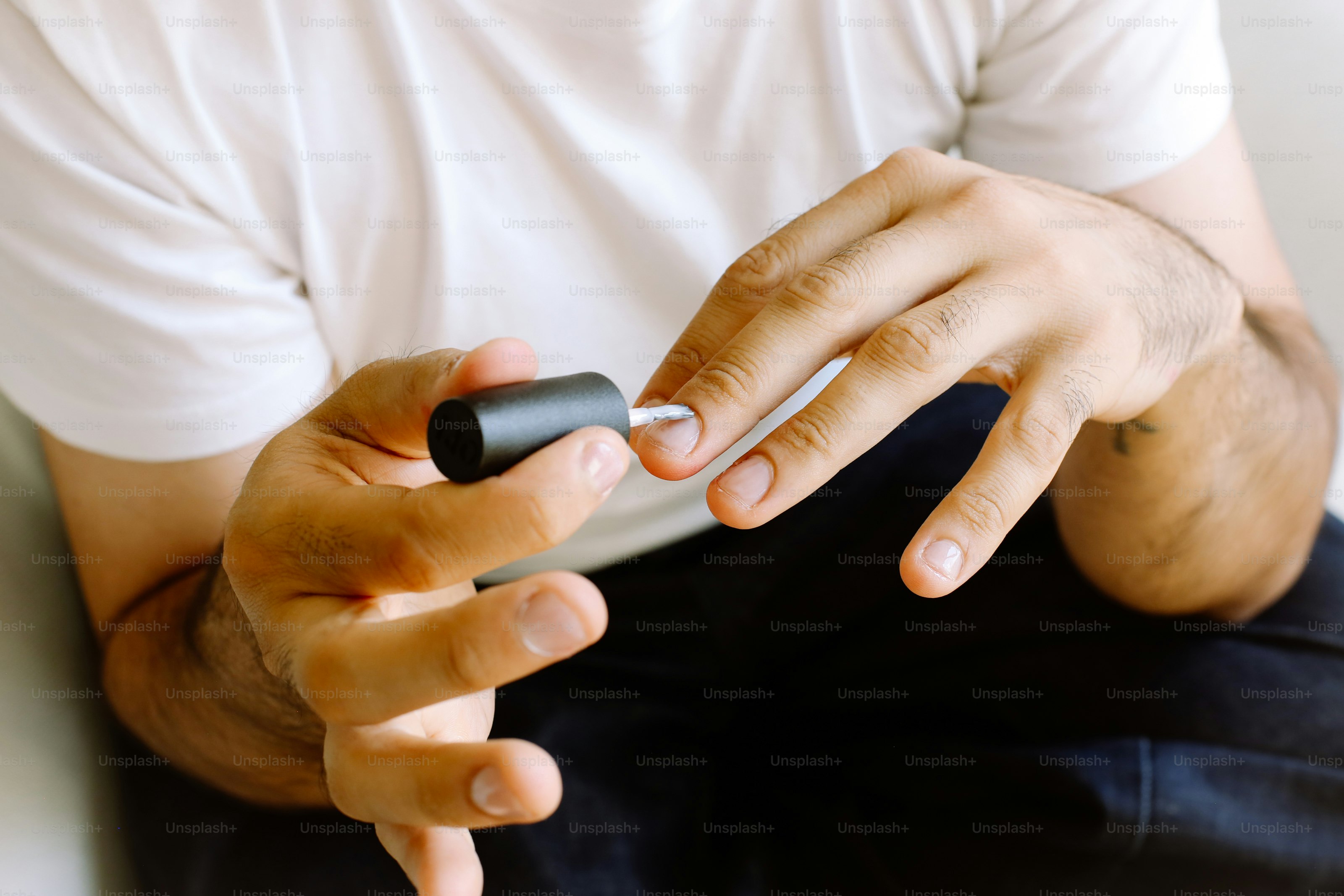 A man sitting on a couch using a cell phone