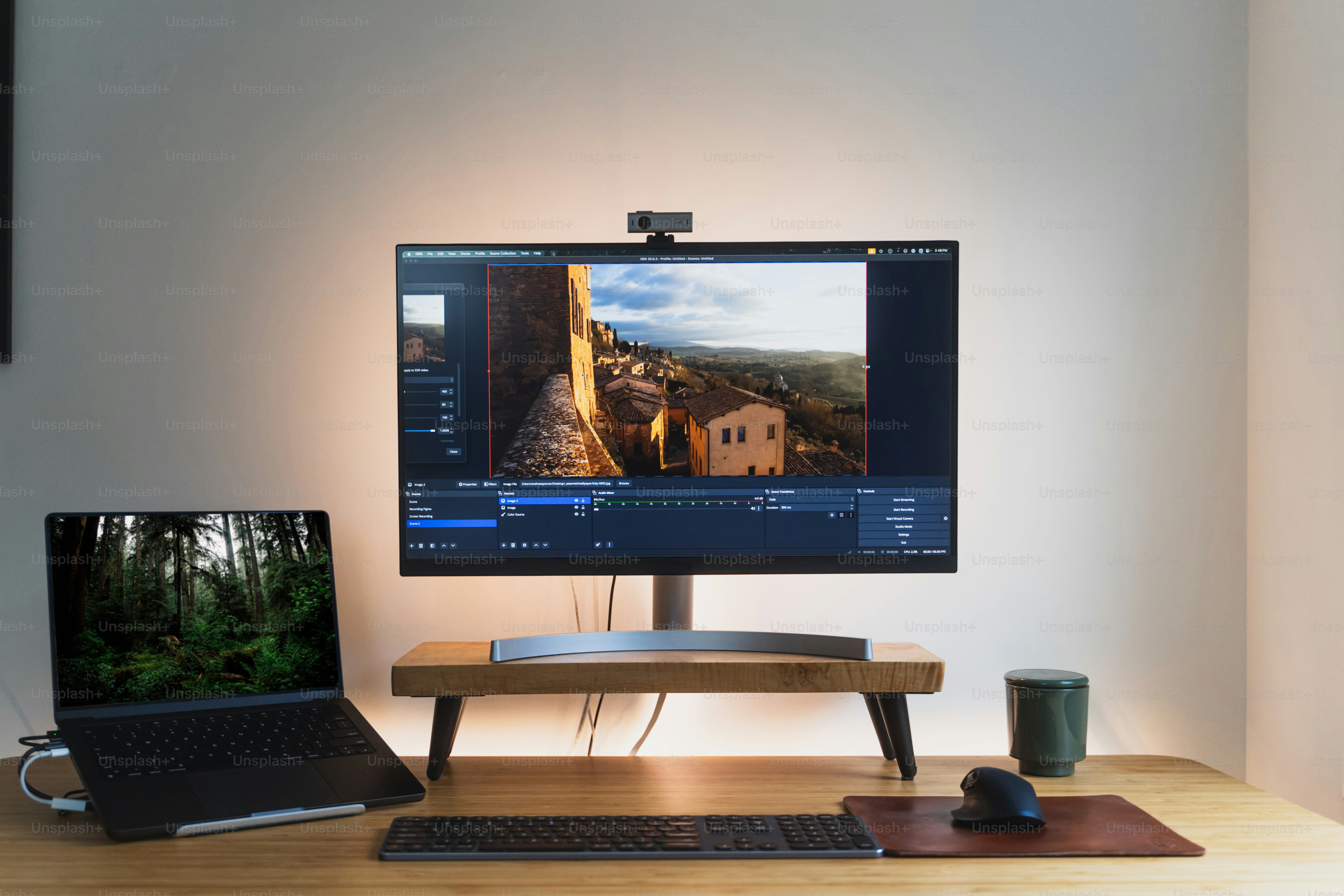 A flat screen TV sitting on top of a wooden desk