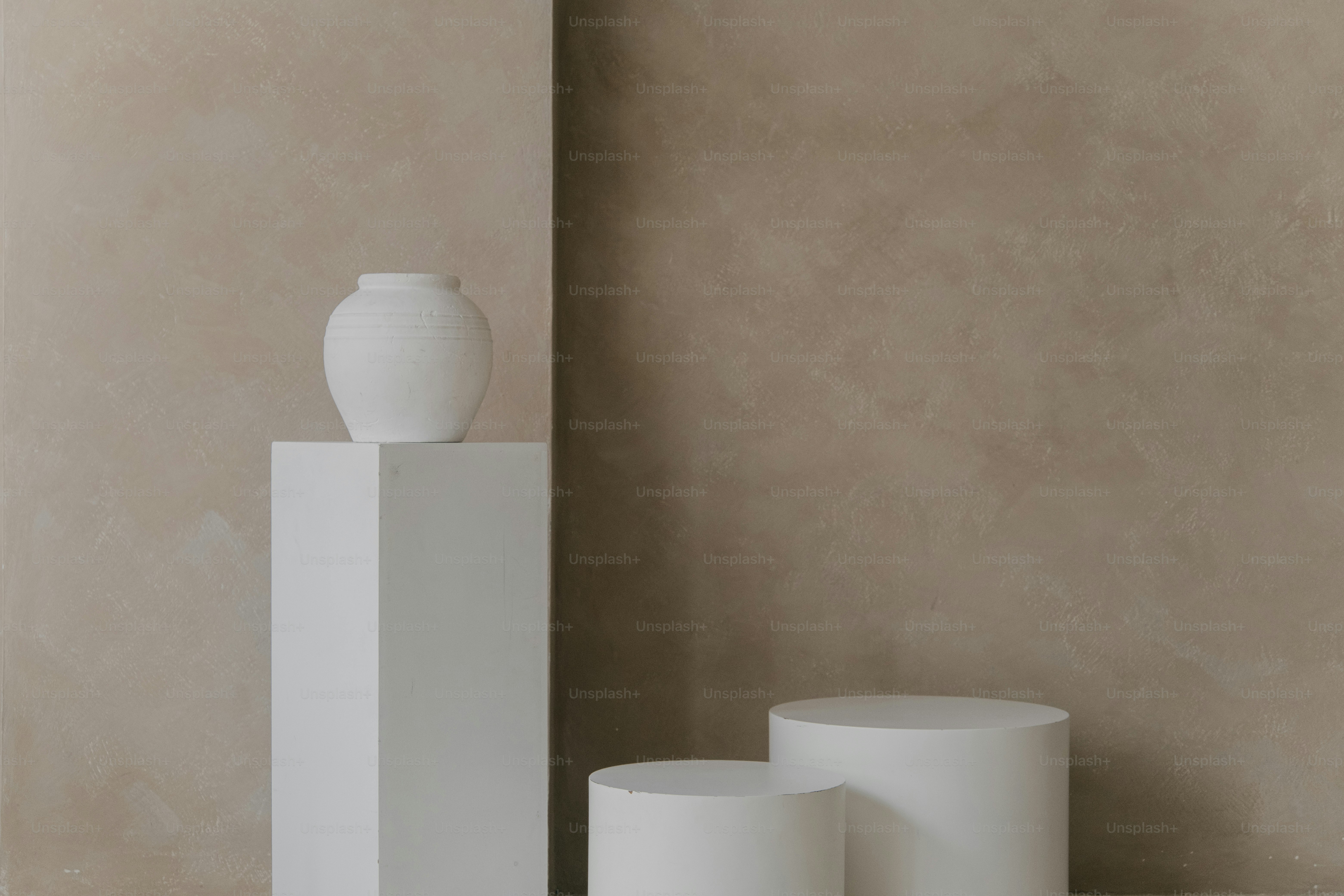 A couple of white vases sitting next to each other