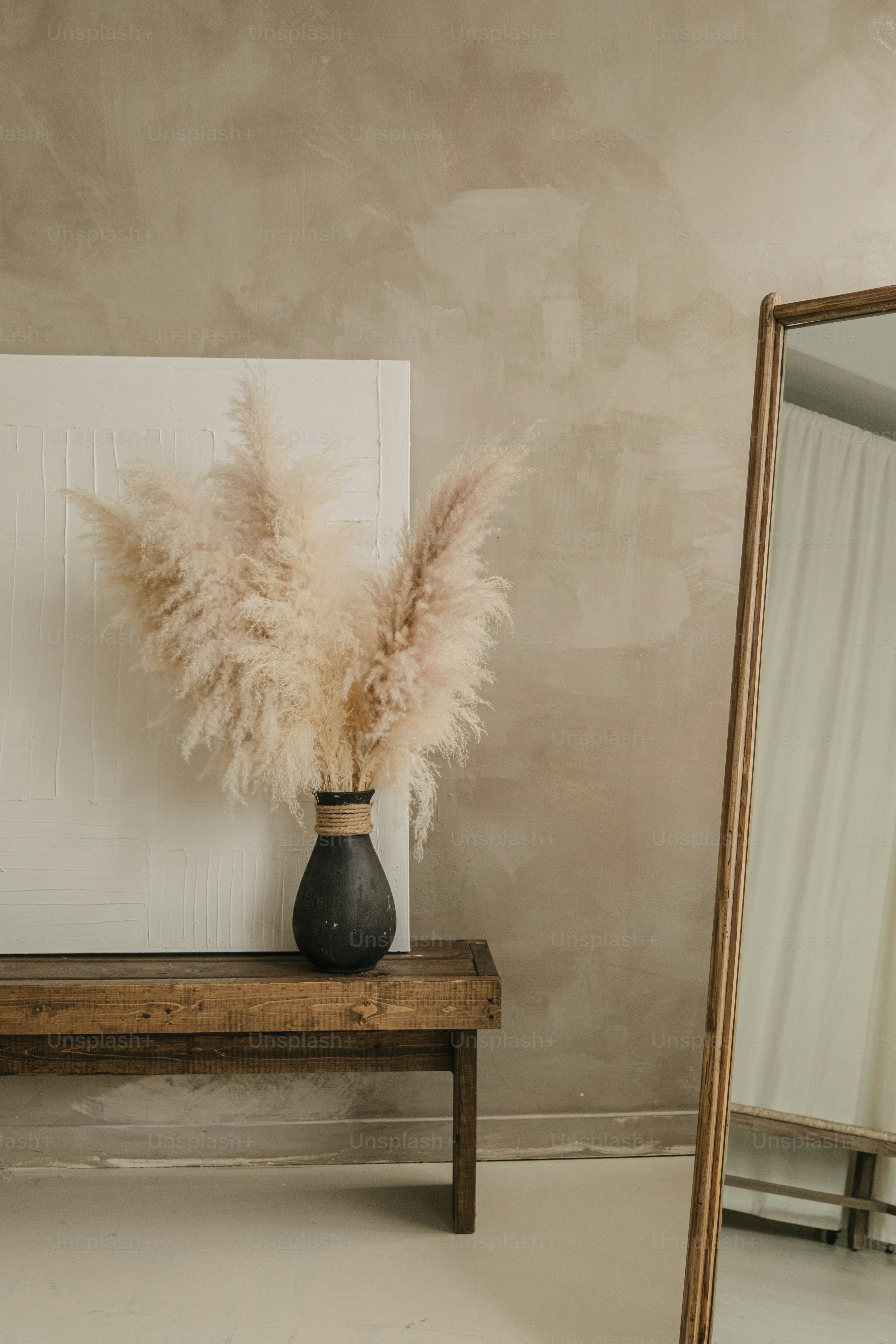 A mirror and a table with a vase on it photo – Interior design Image on ...