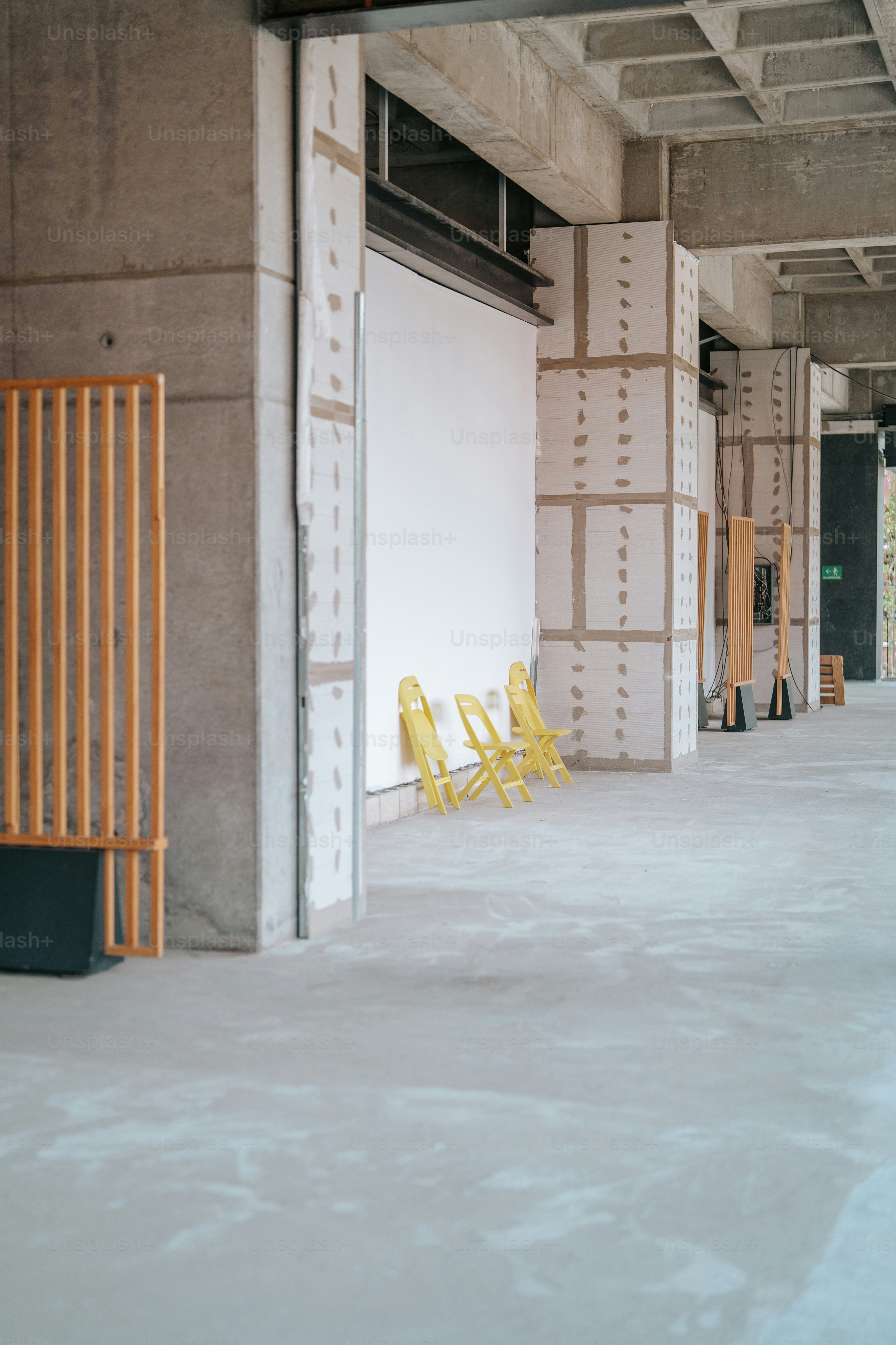 A yellow chair sitting in an empty building