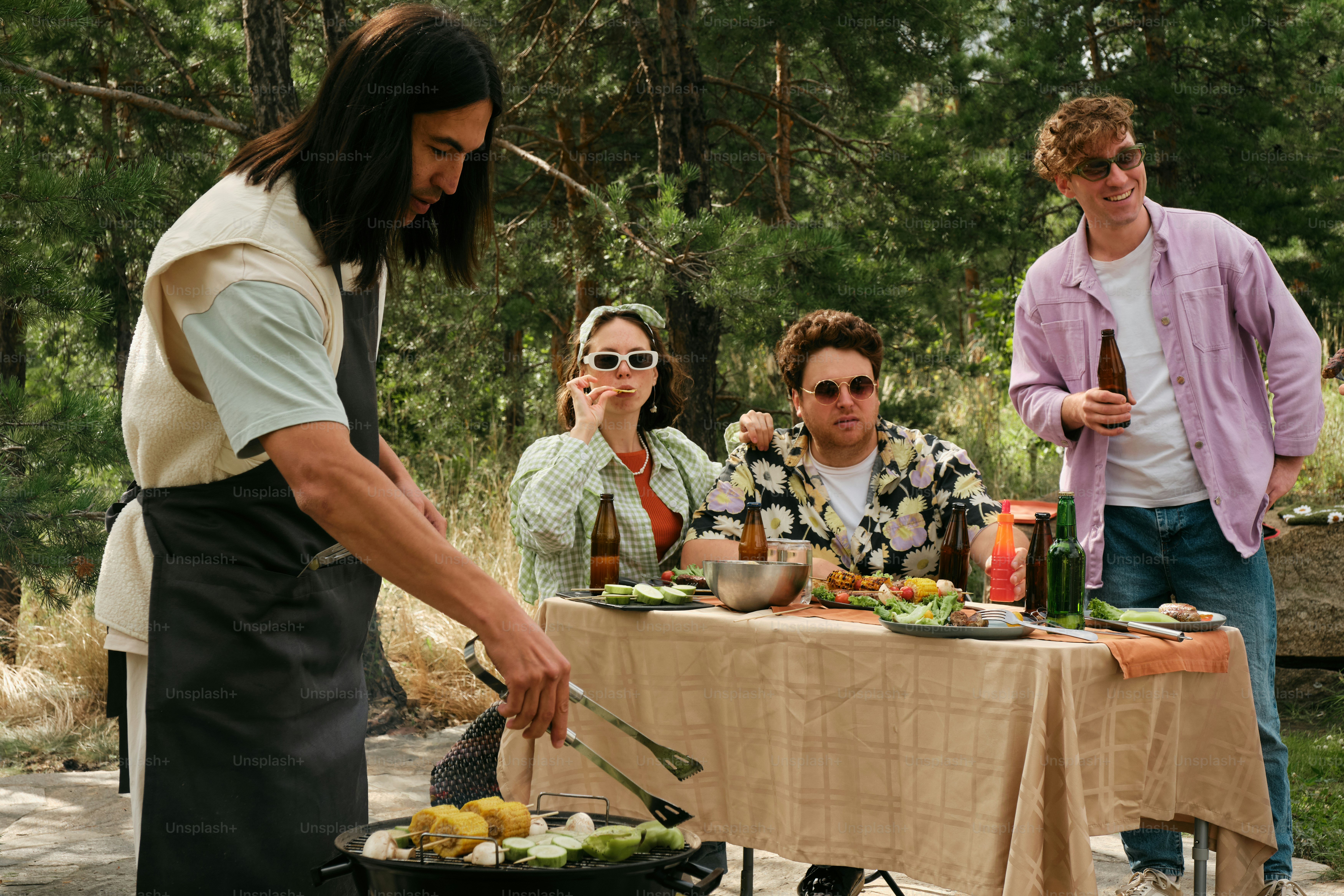 食べ物が置かれたテーブルの周りに立っている人々のグループ