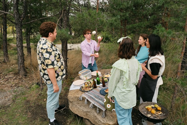 Neighbors gathered around a picnic table at a cookout
