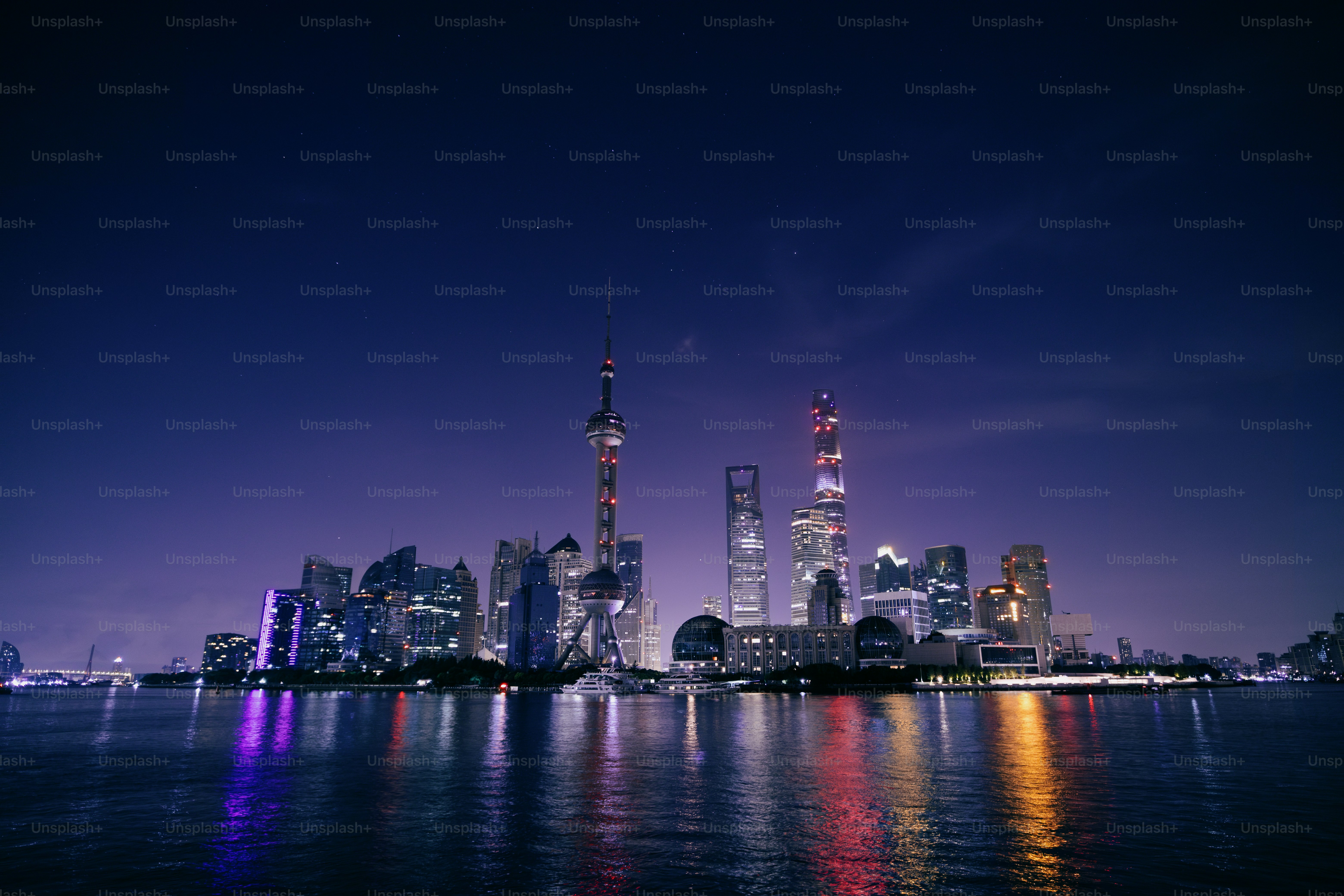 A view of a city at night from the water