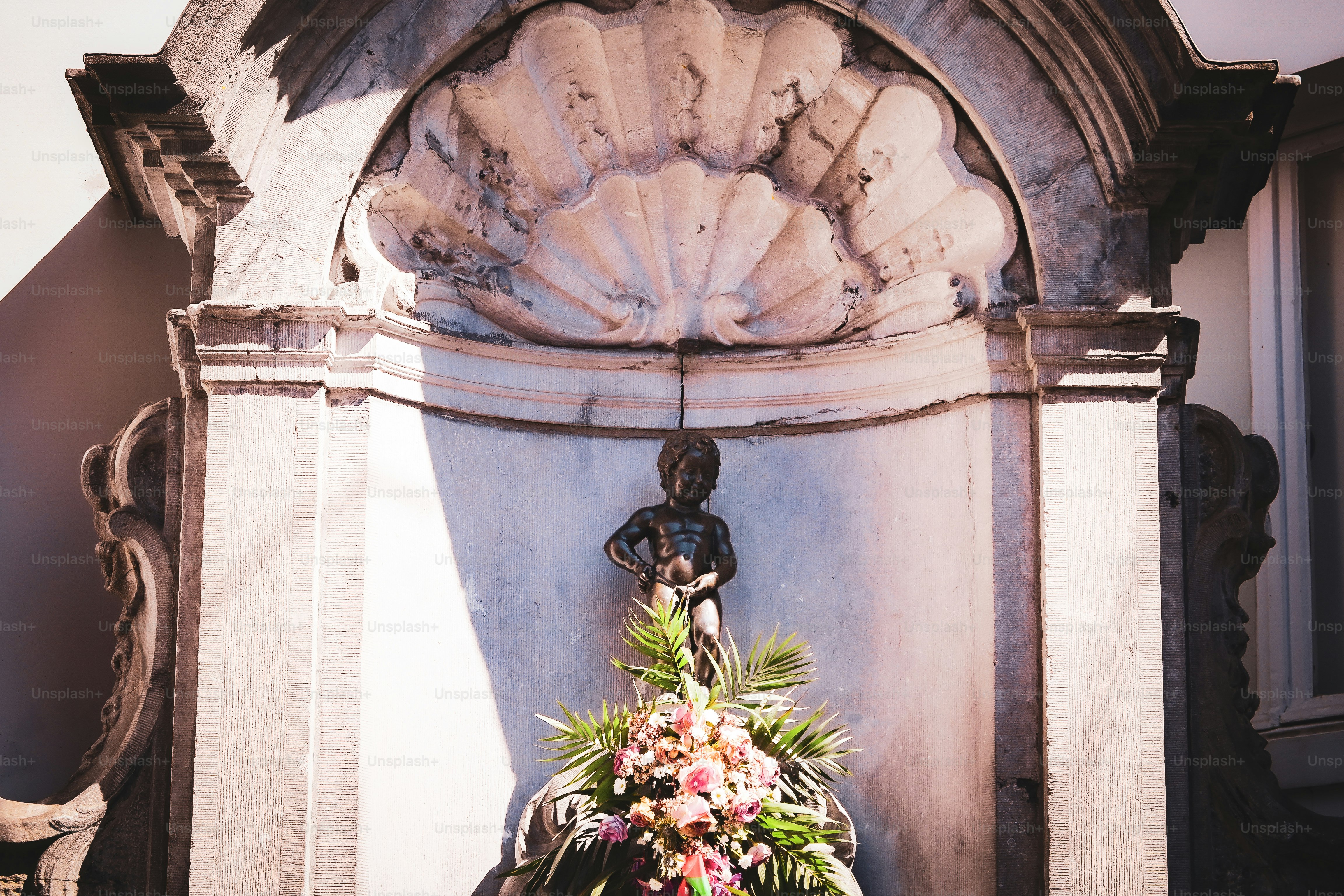 A fountain with a bunch of flowers on it