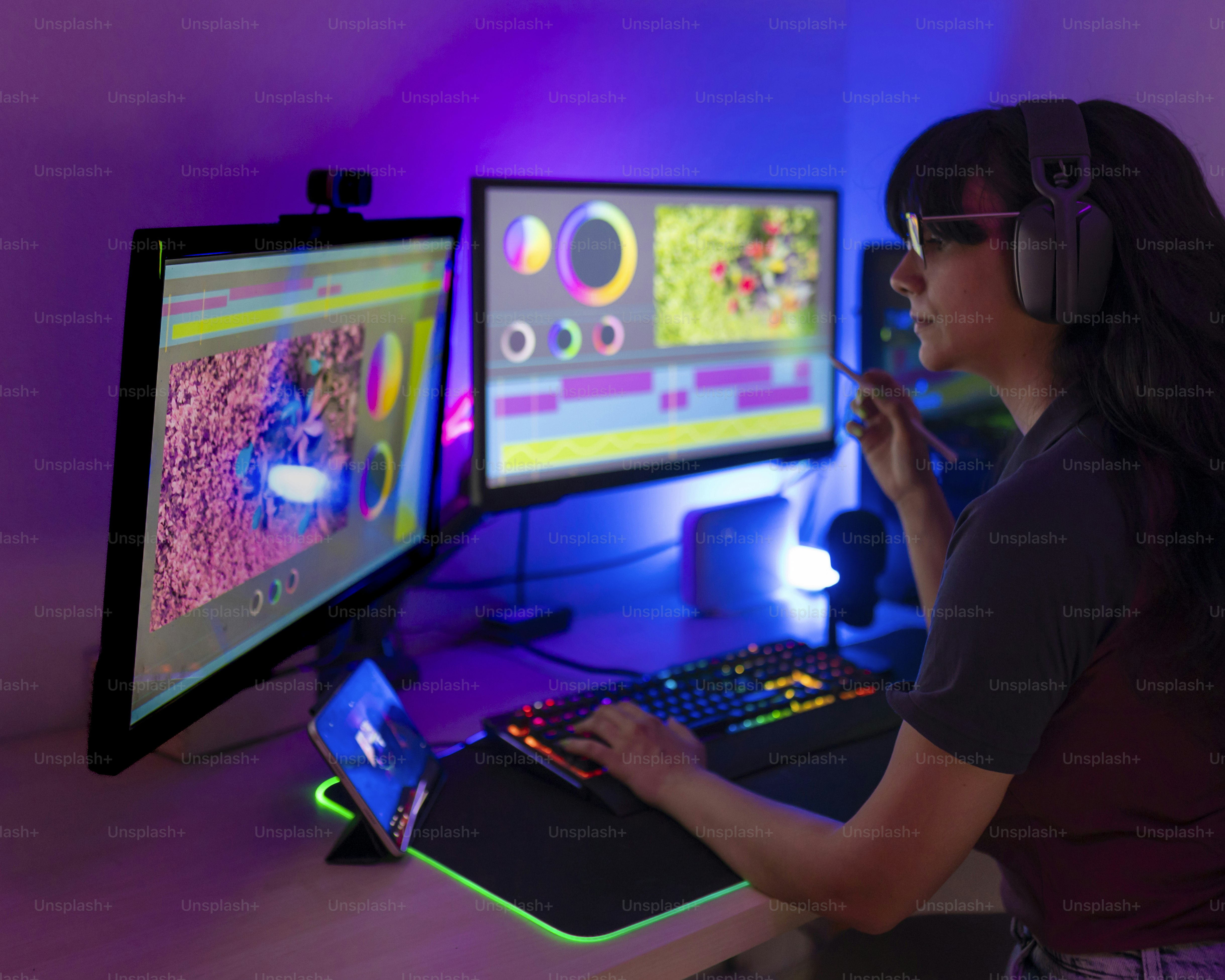 A woman sitting in front of two computer monitors