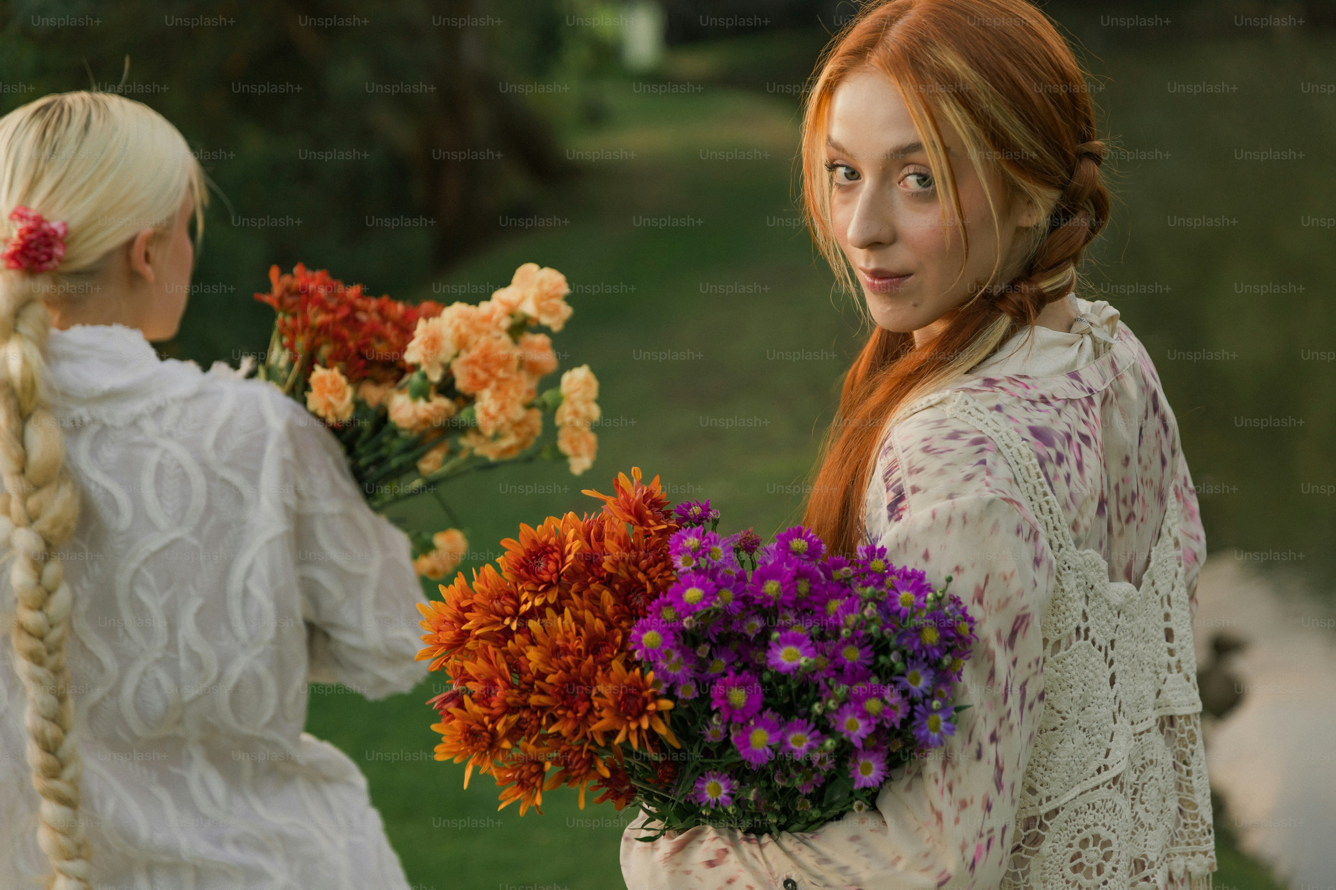 A woman with long red hair holding a bouquet of flowers photo – Simple ...