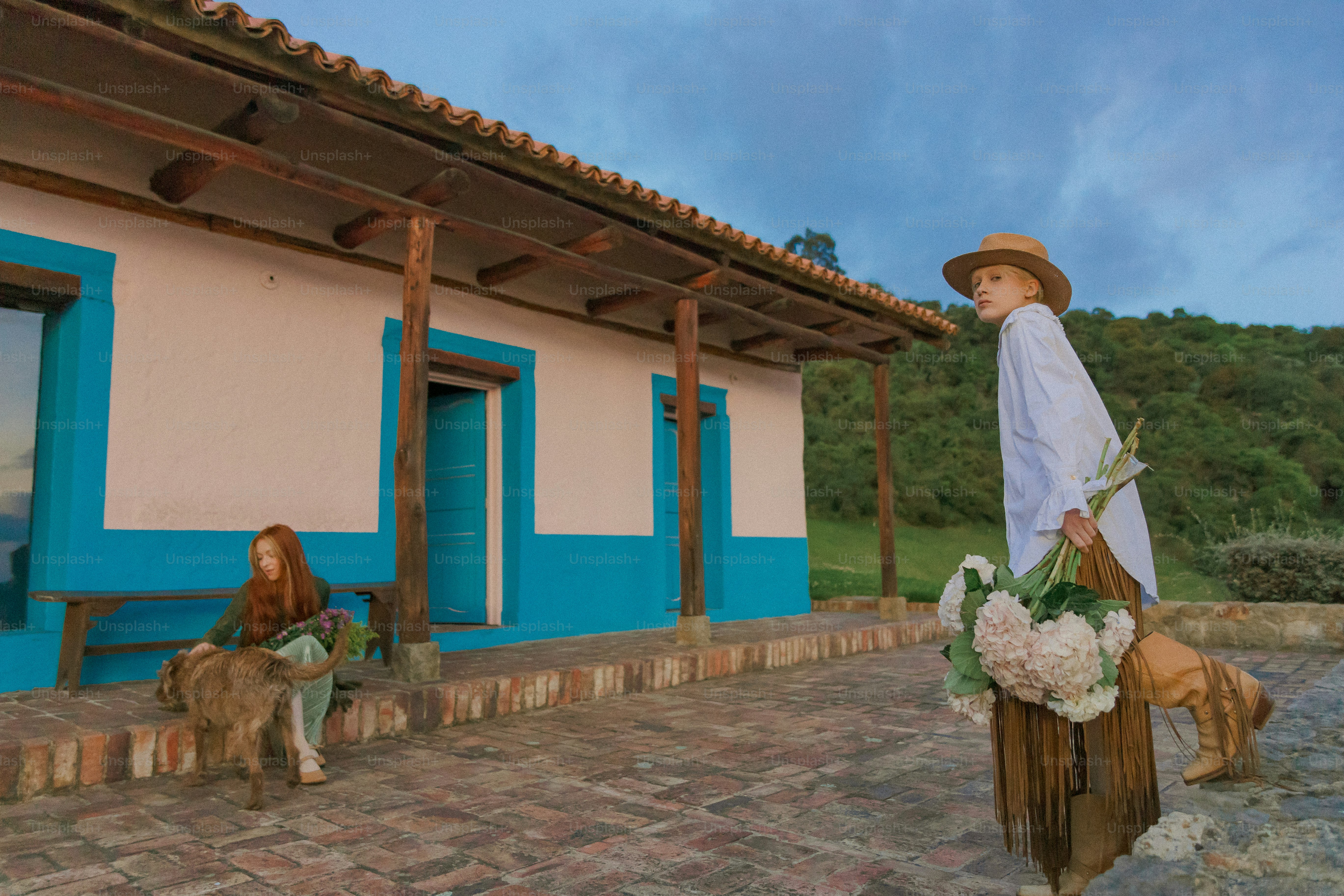 A man walking a dog down a street next to a building
