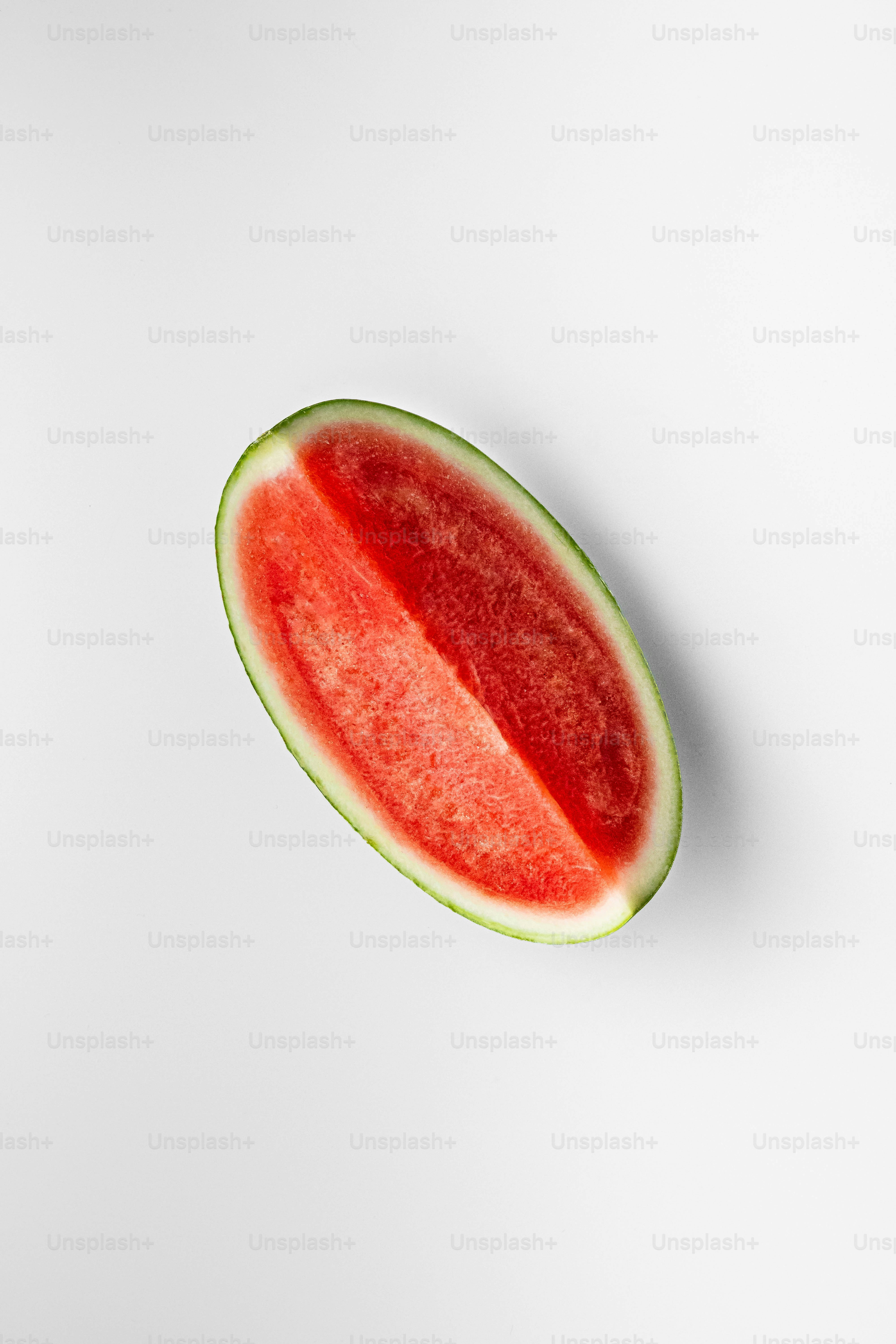 A slice of watermelon on a white surface