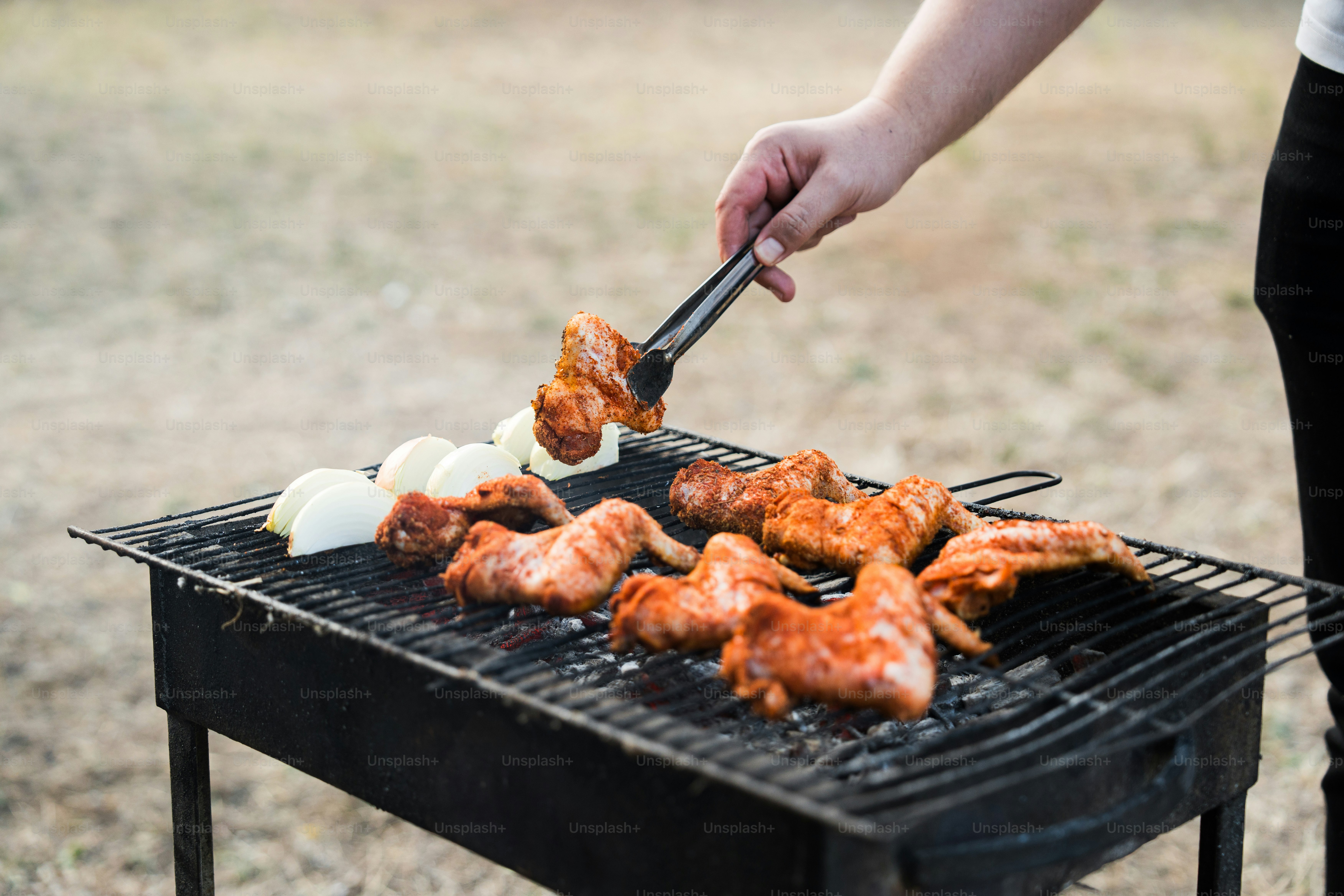 A person is grilling chicken on a grill photo – Family Image on Unsplash