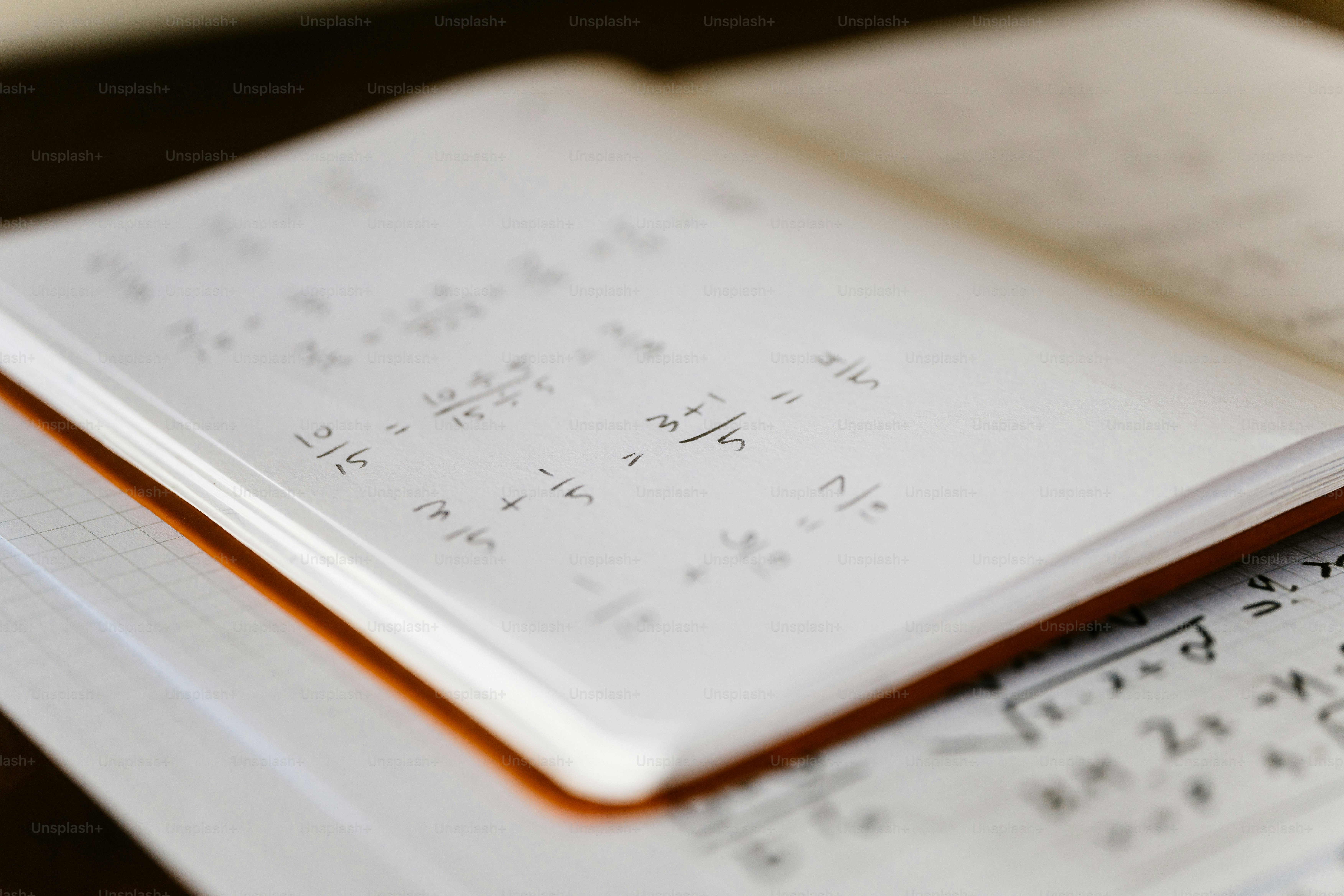 A close up of a book with a pen on top of it