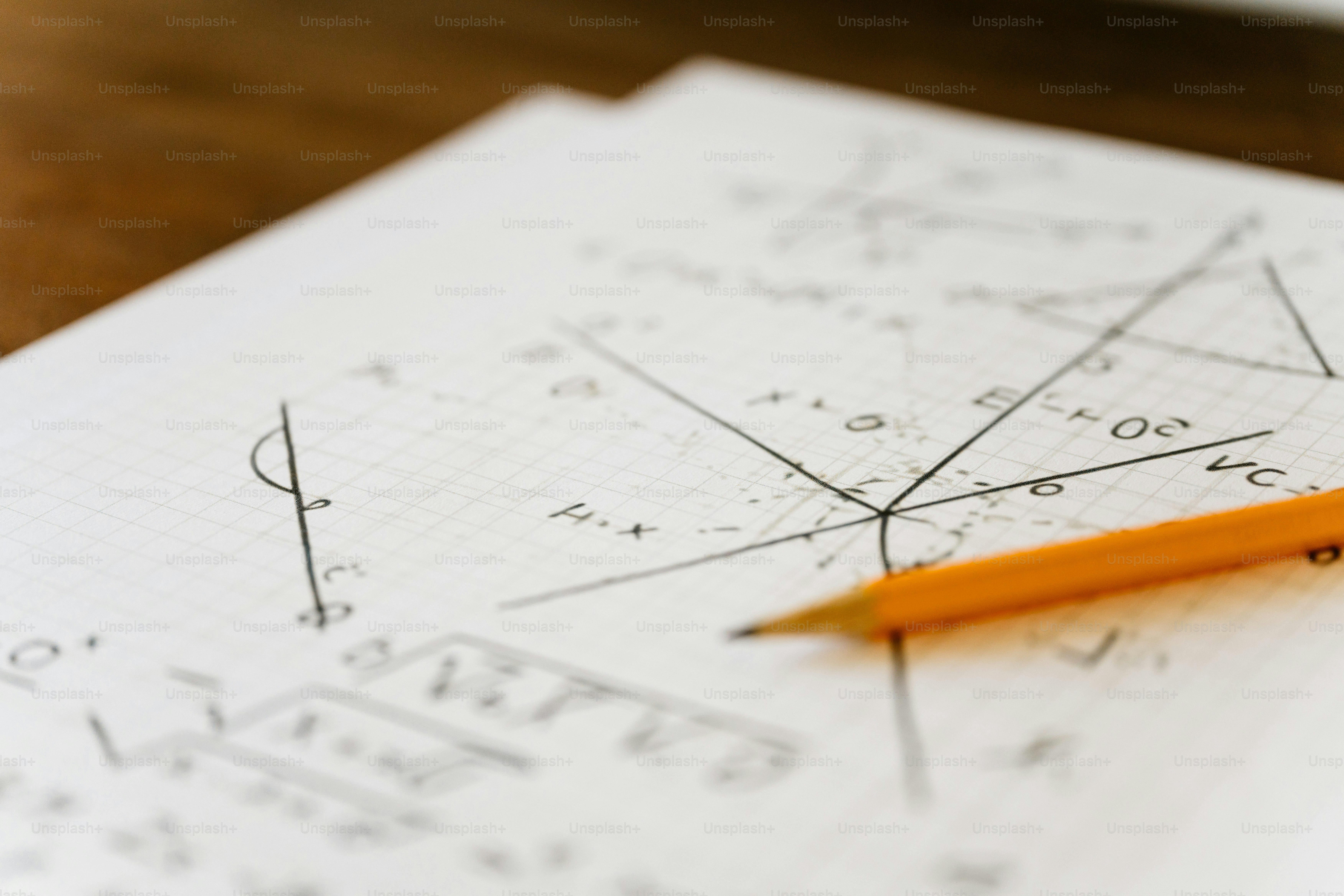 A pencil resting on top of a piece of paper