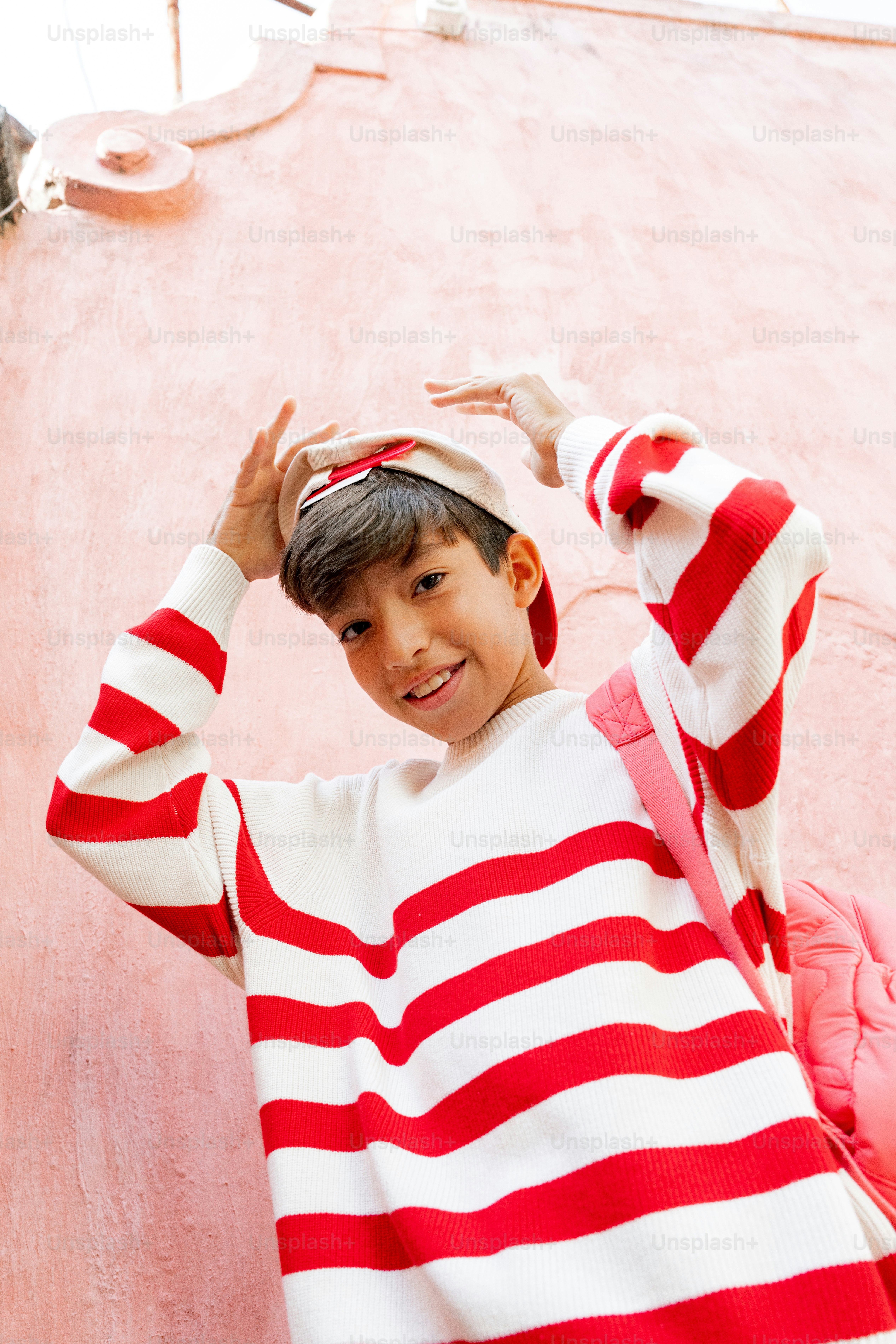 A young boy wearing a red and white striped shirt photo – Pattern Image ...
