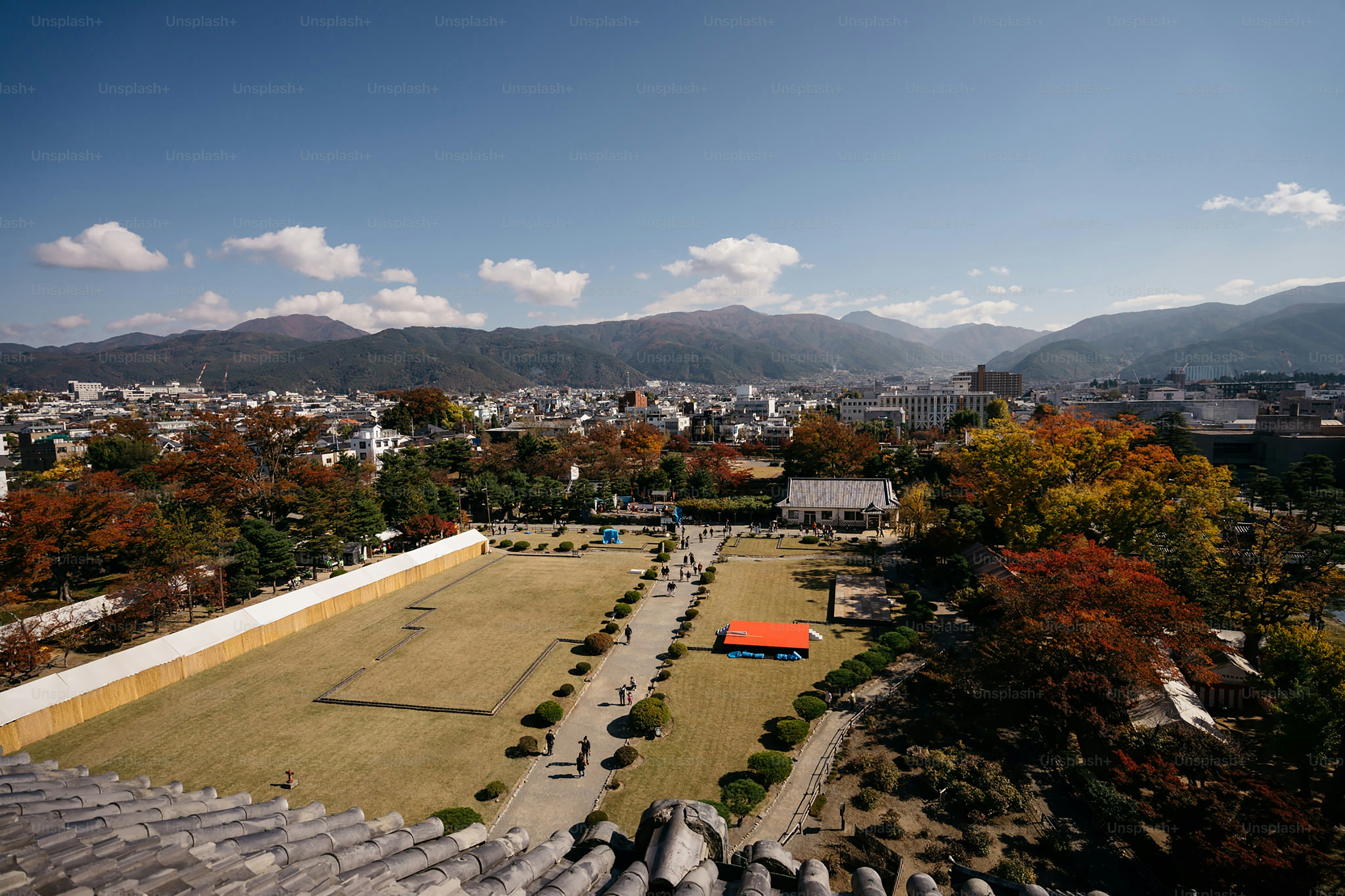 An aerial view of a city with a soccer field