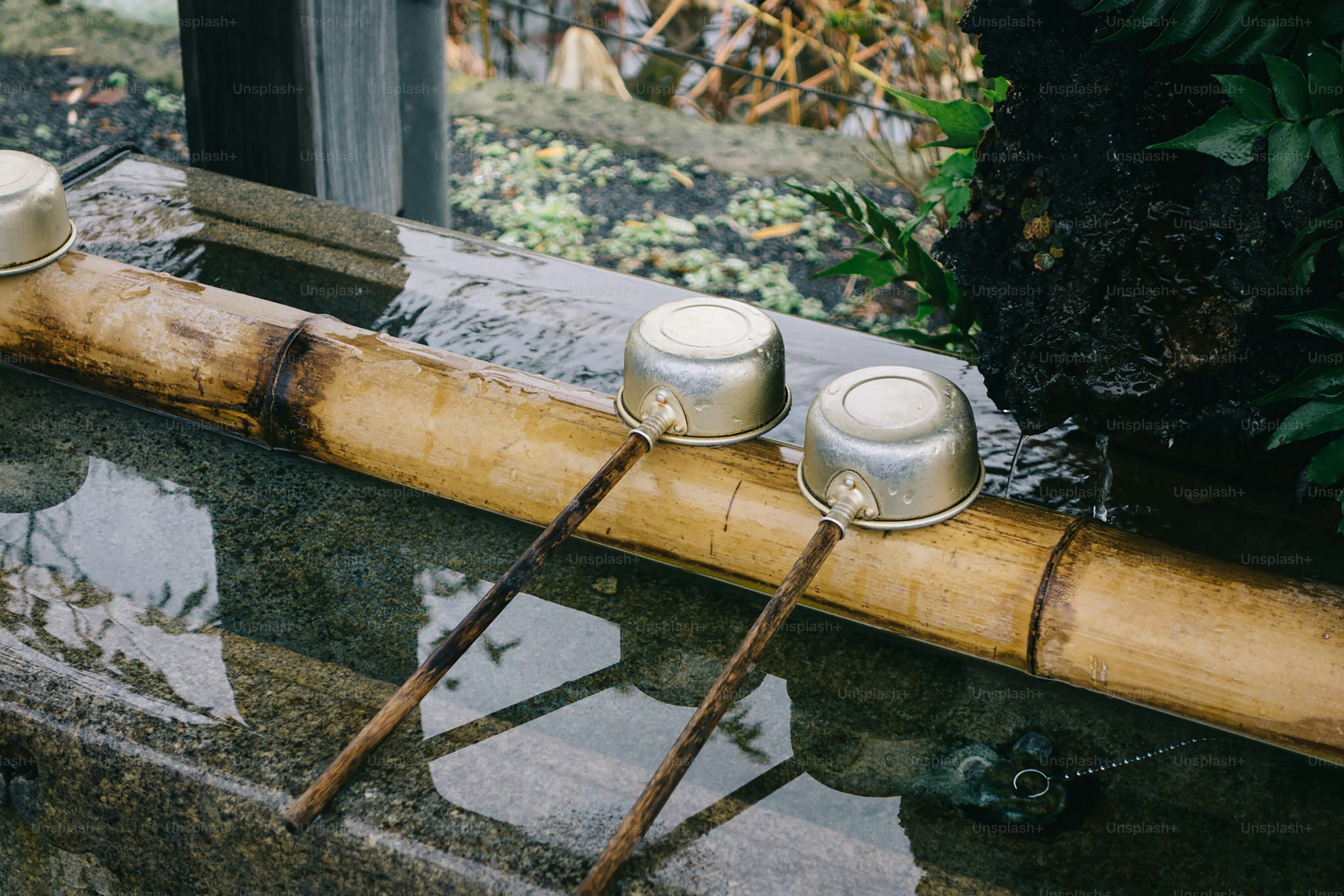 Two candles sitting on top of a bamboo stick