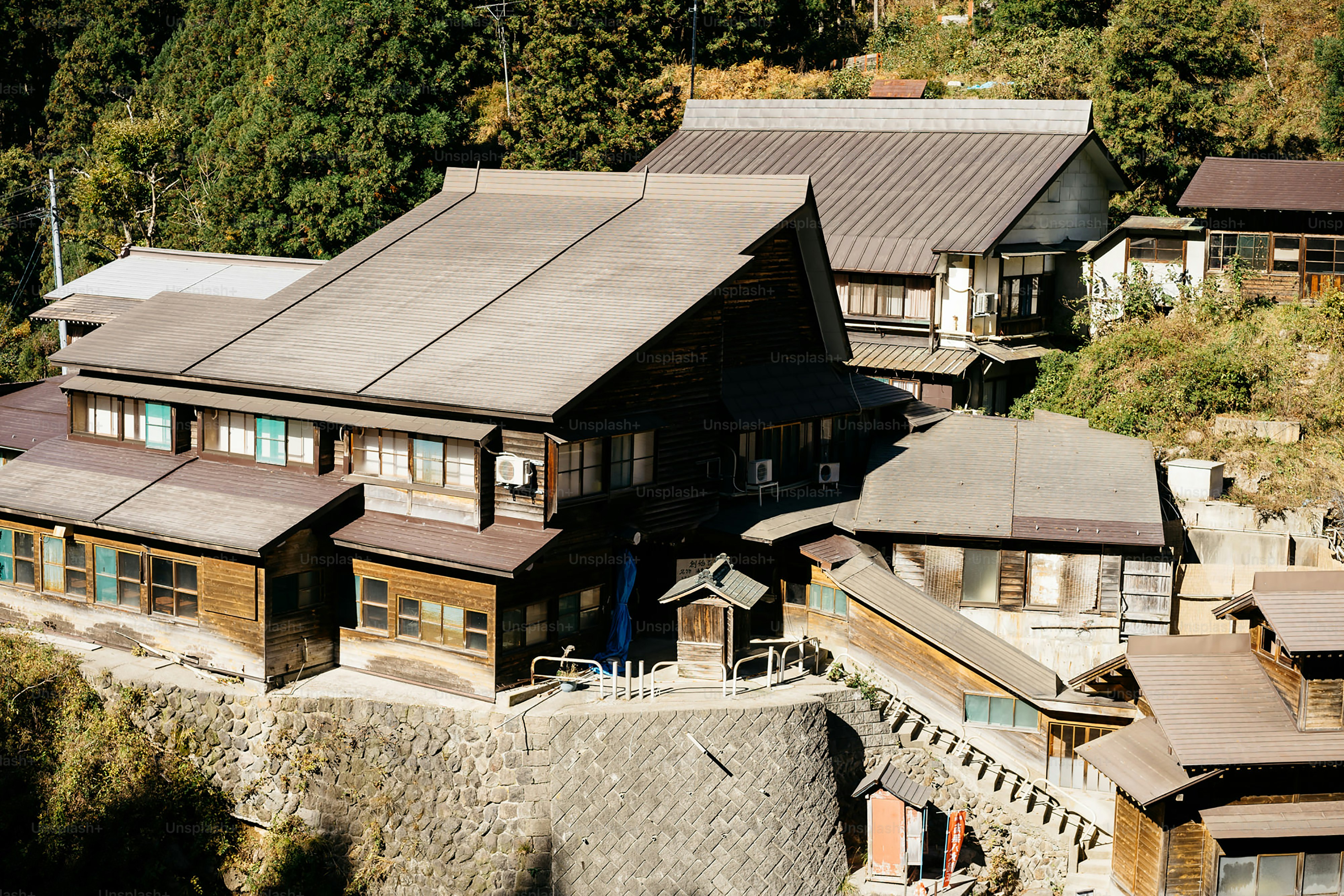 An aerial view of a village with a mountain in the background
