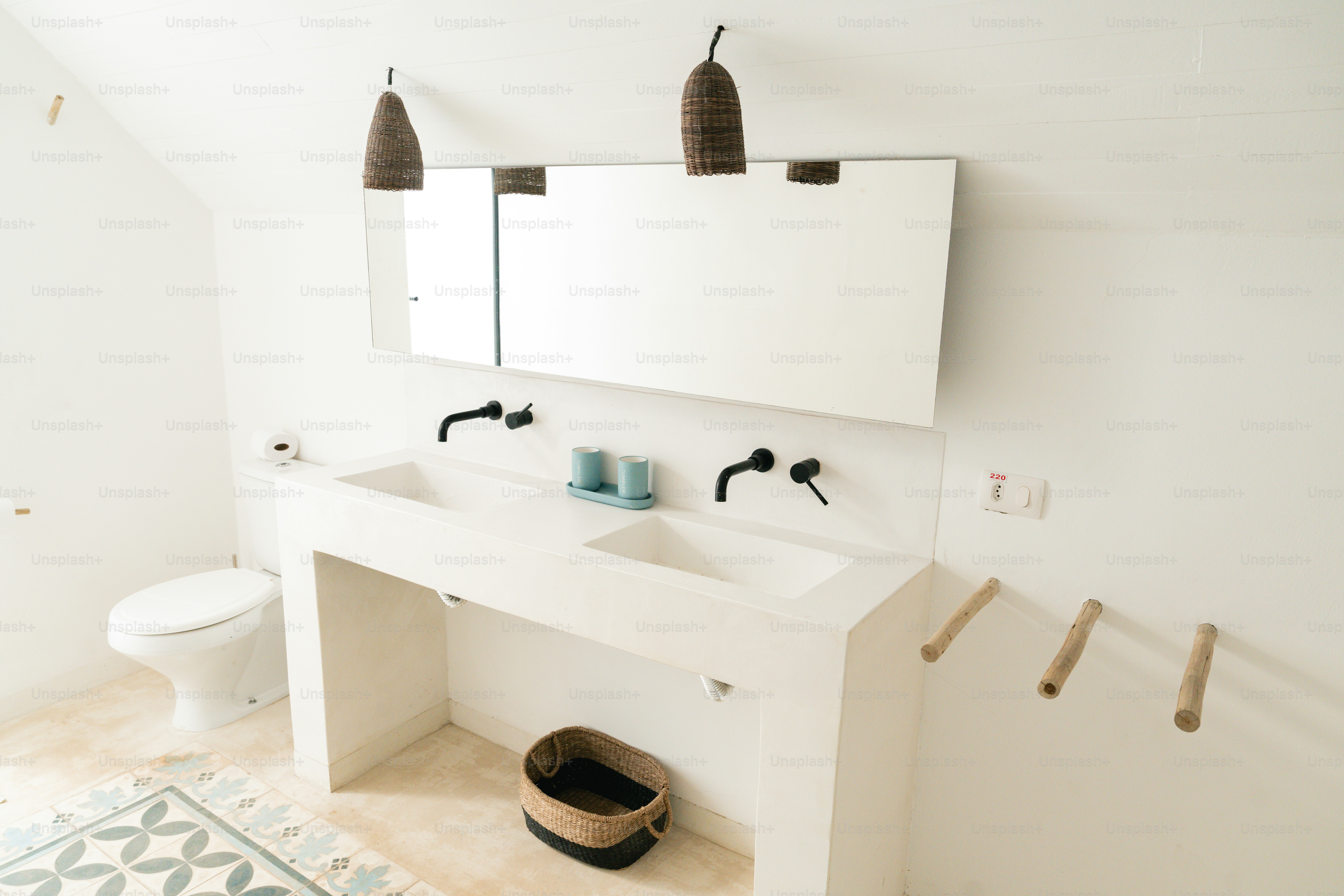 A bathroom with a sink, mirror and toilet