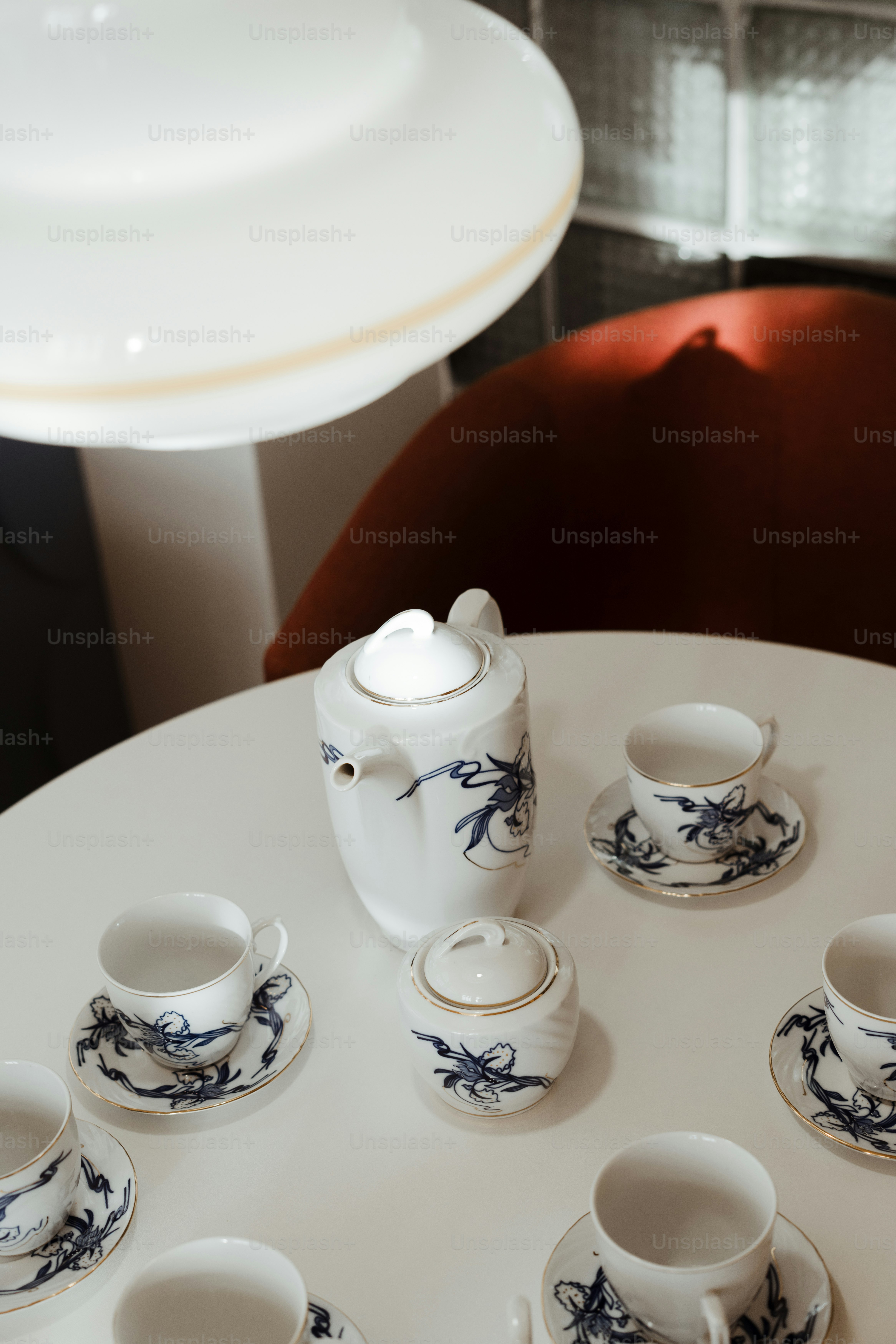 A white table topped with lots of cups and saucers