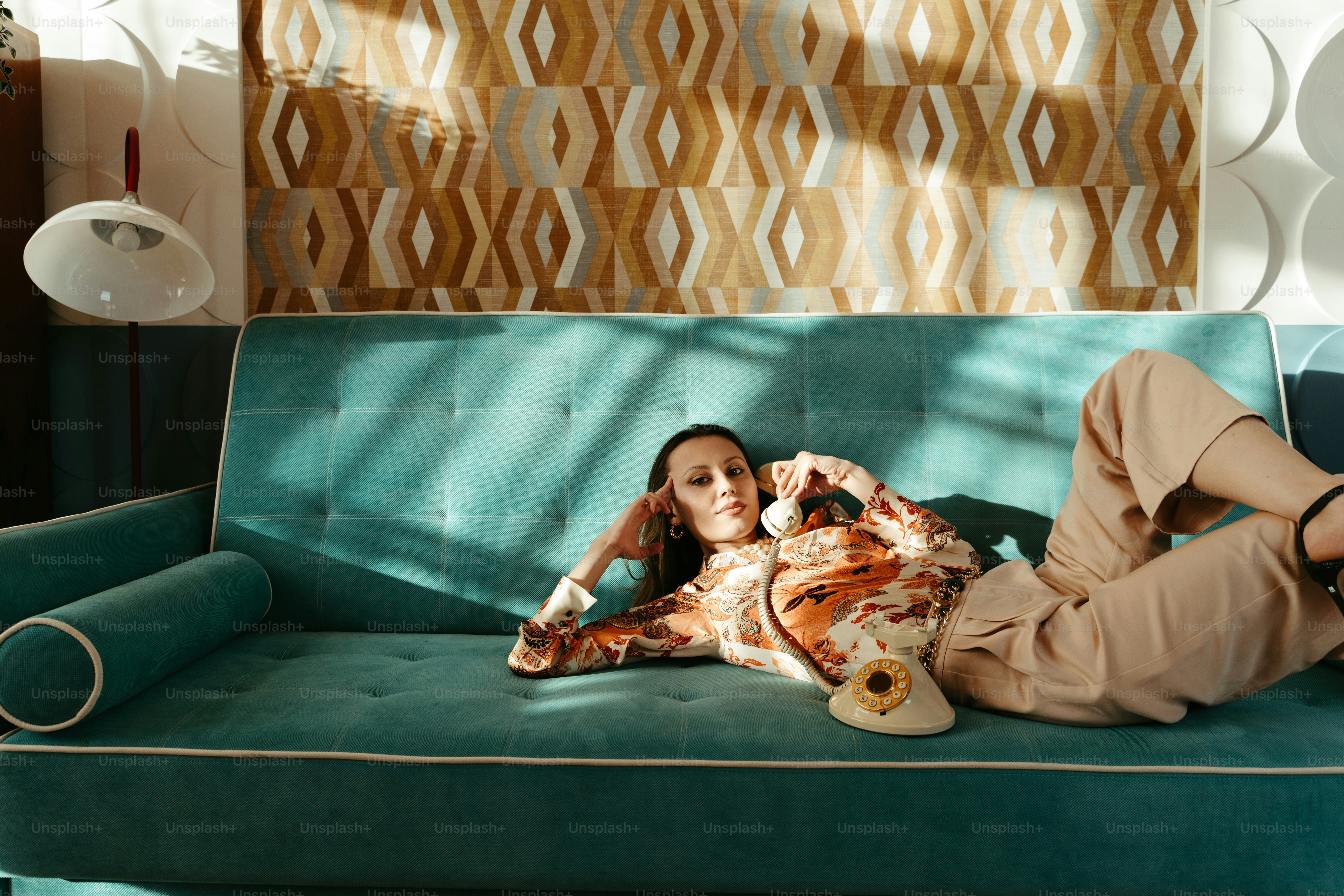 A woman laying on a couch with a stuffed animal