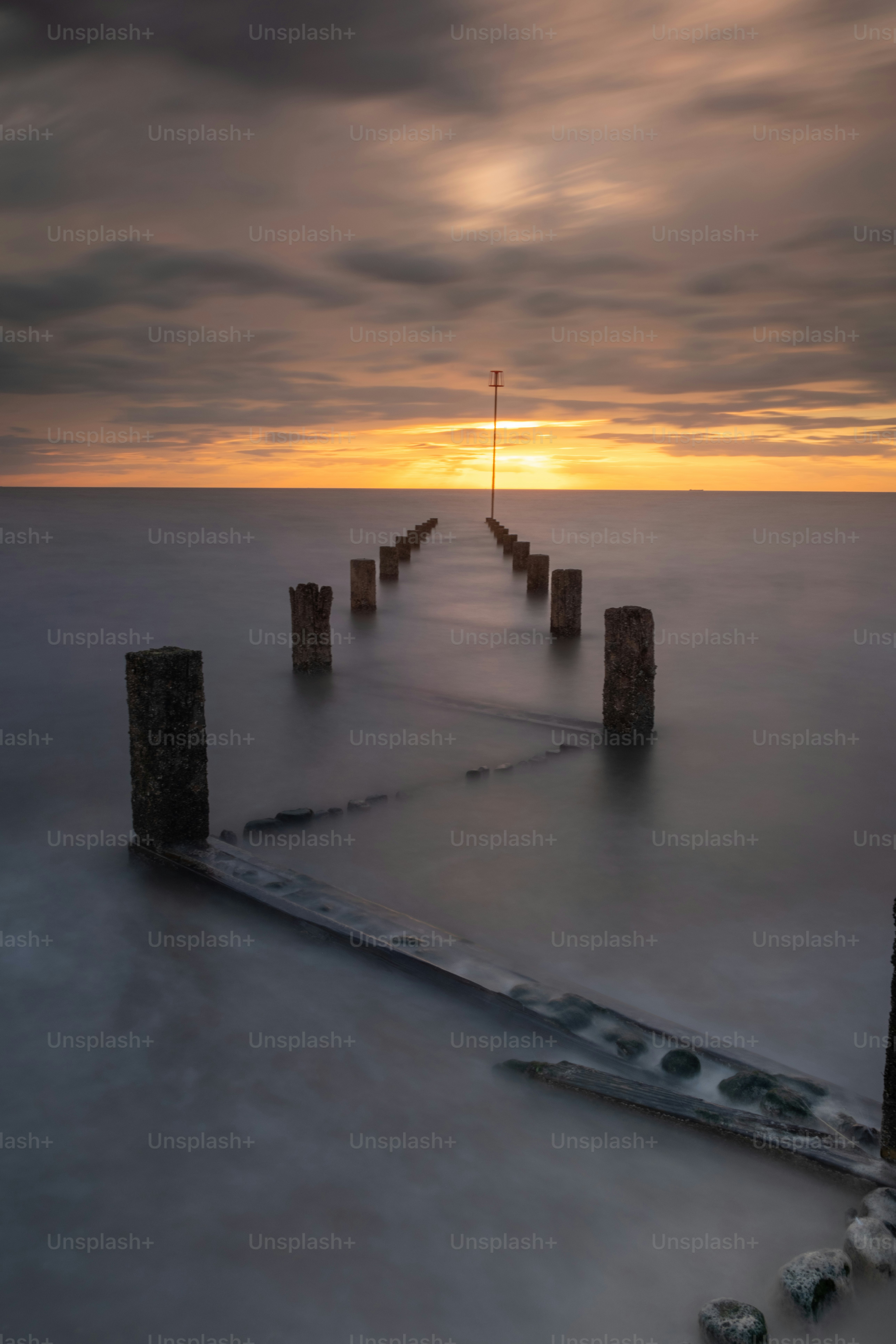 A long pier in the middle of a body of water photo – Heacham Image on ...