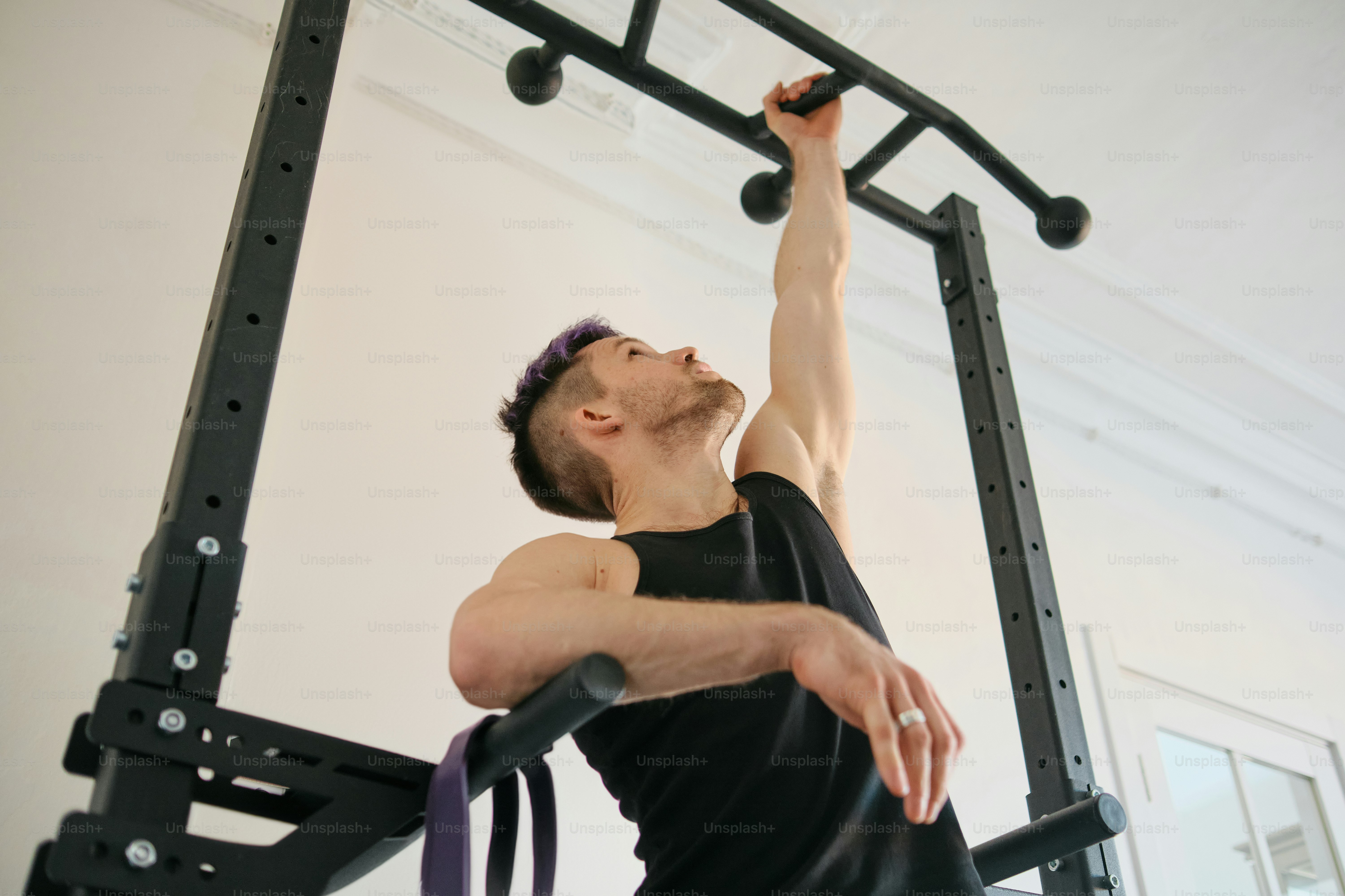 A man doing a pull up on a pull up machine