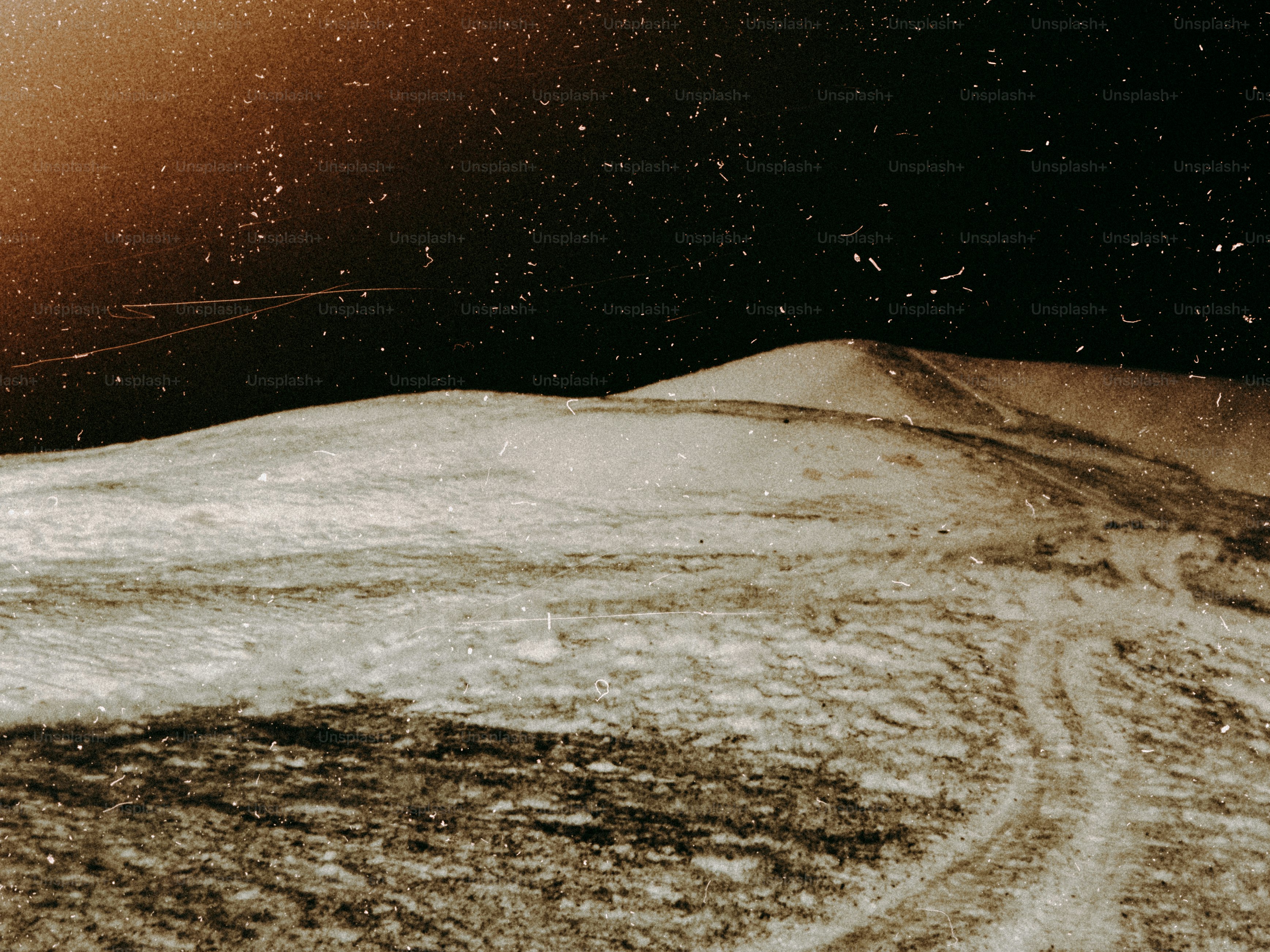 A man riding a snowboard down a snow covered slope