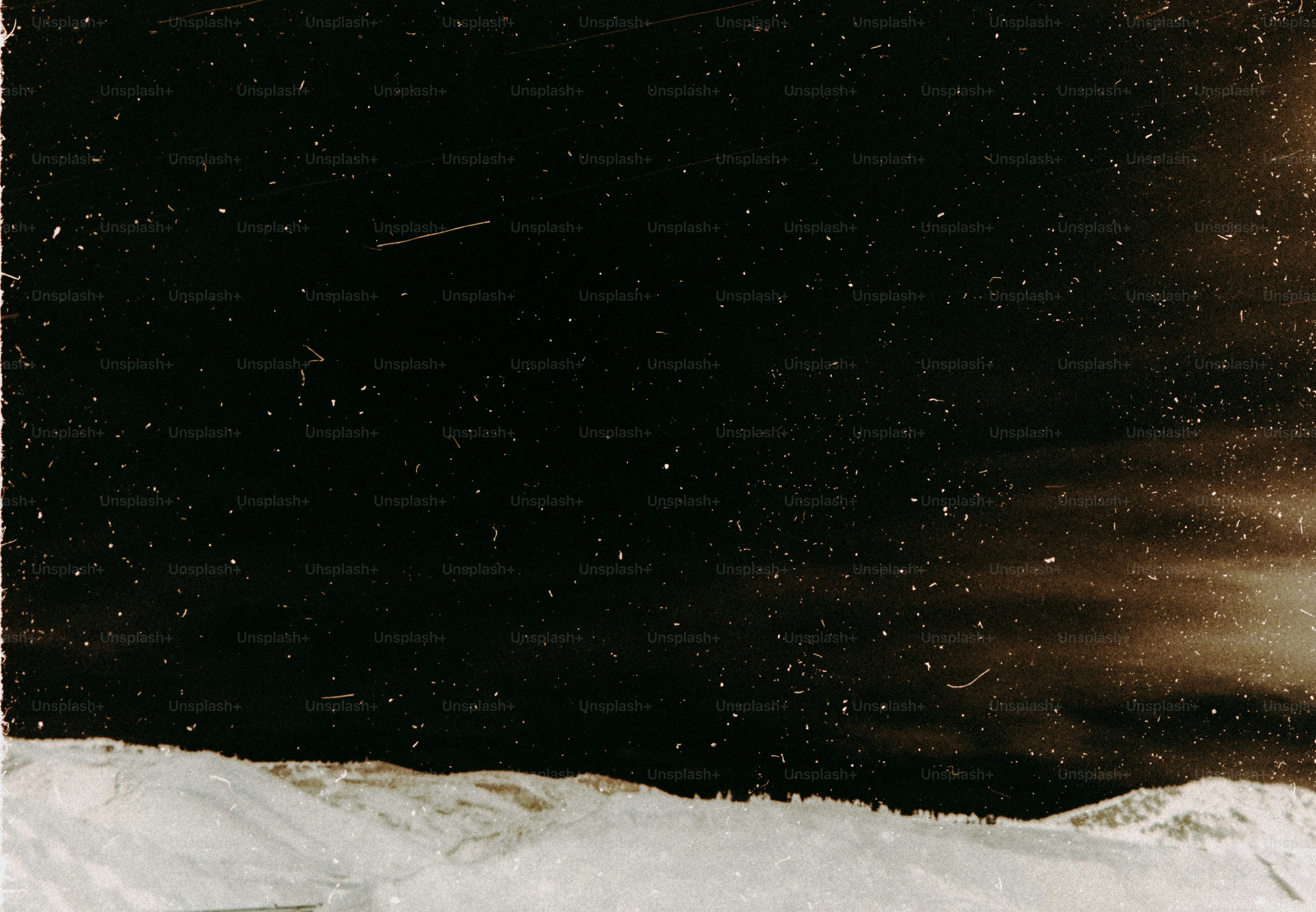 A man riding a snowboard down a snow covered slope