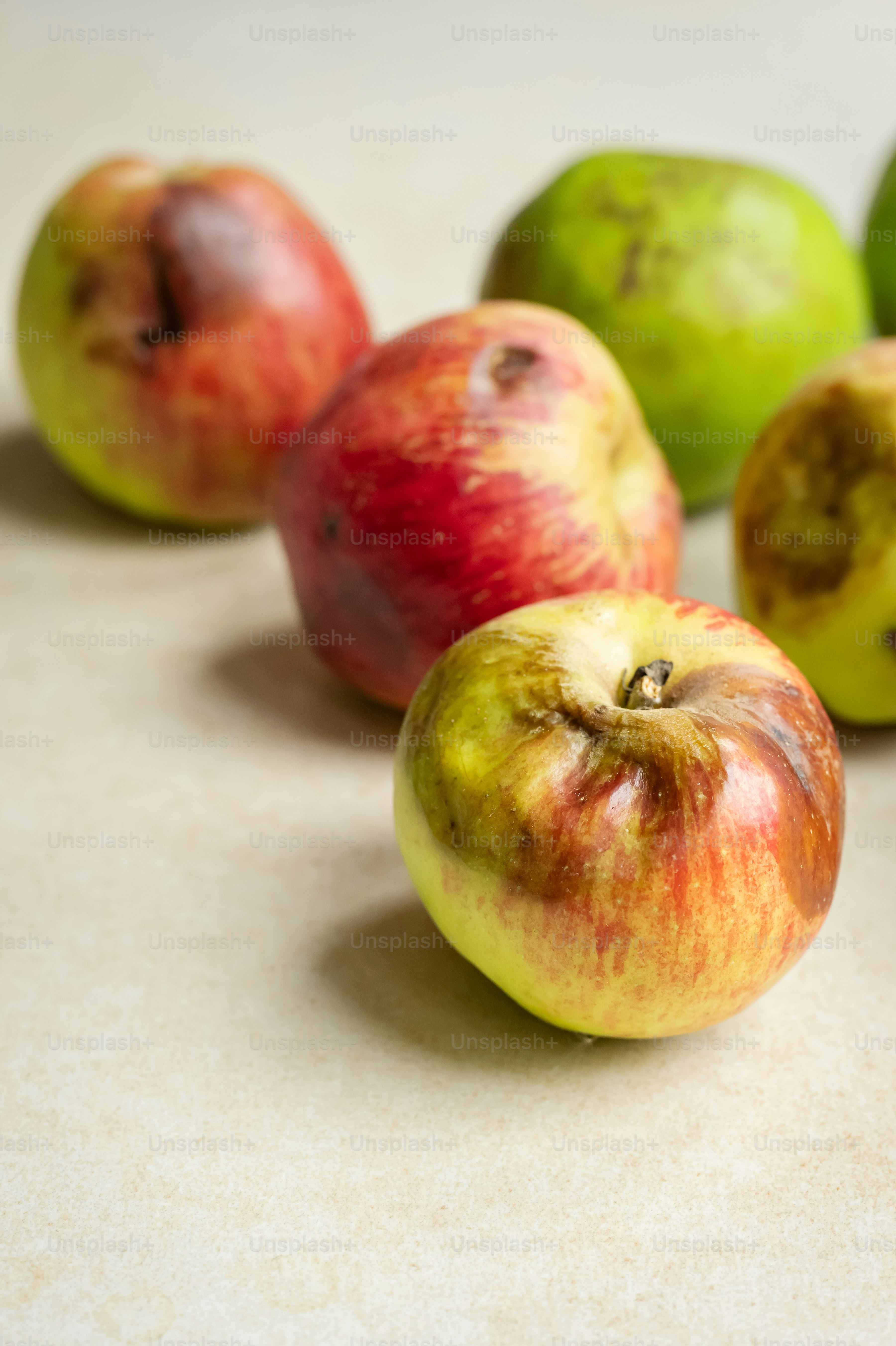 A group of apples sitting on top of a counter