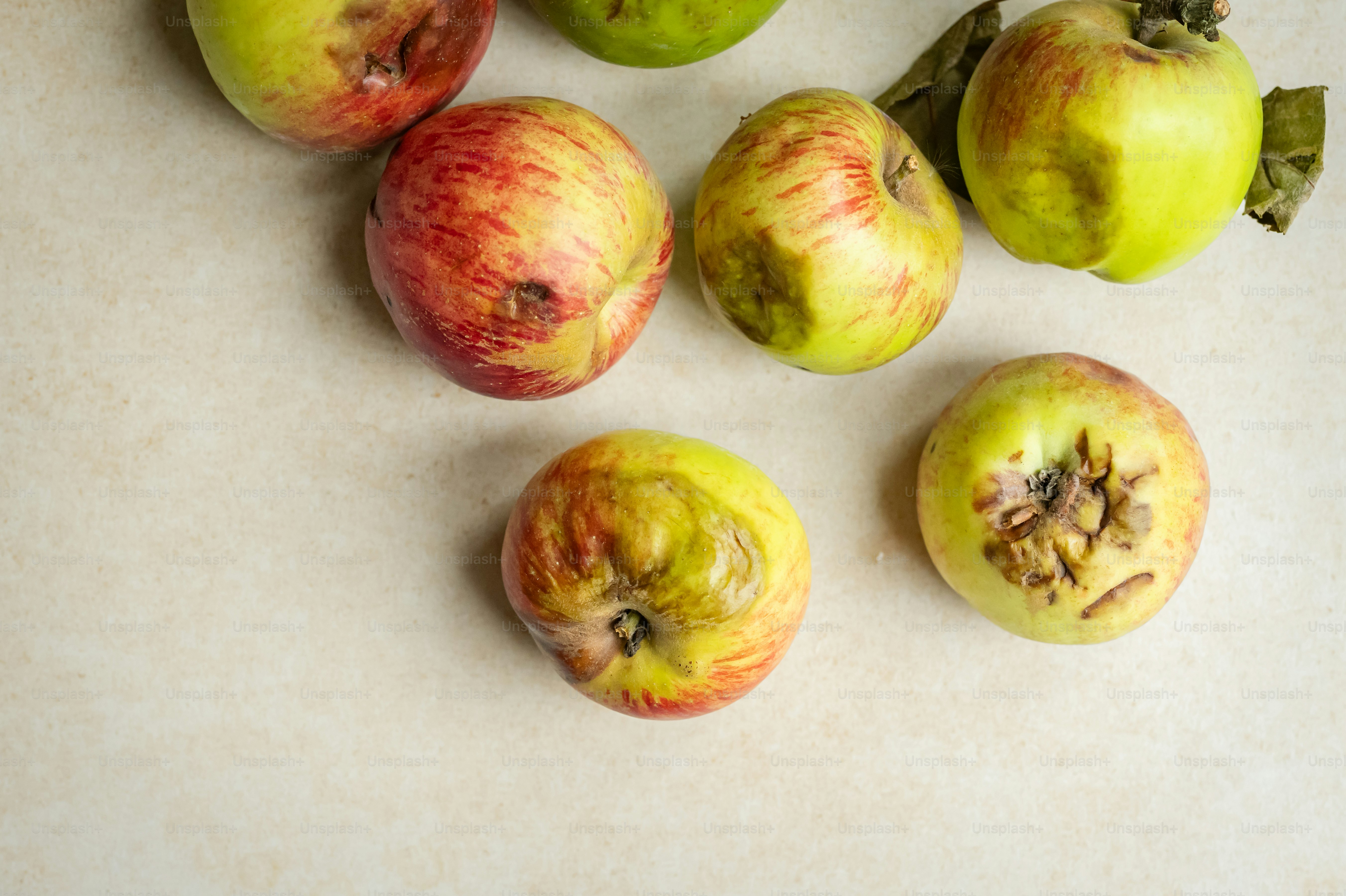 A group of apples sitting on top of a counter