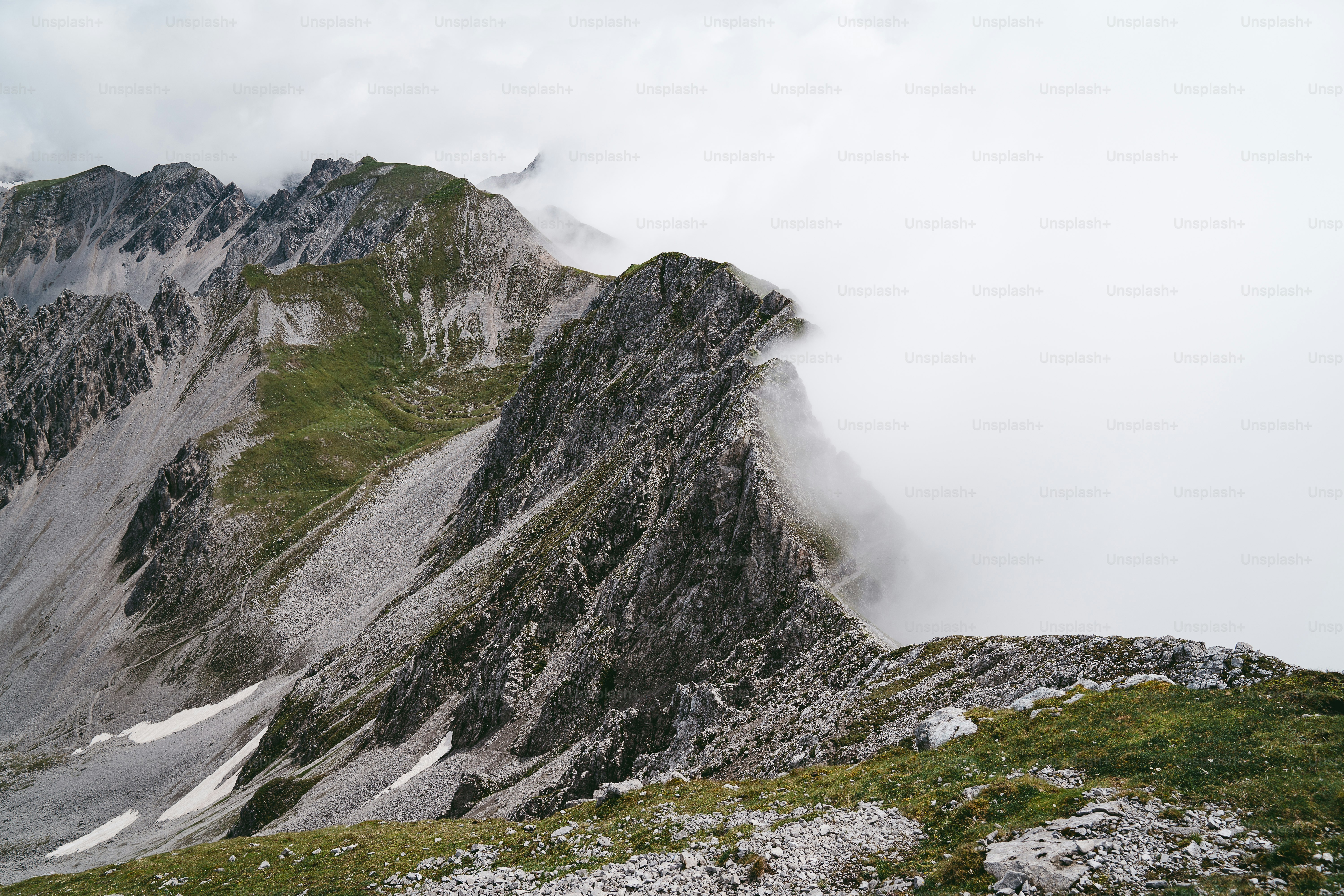 A person standing on top of a mountain with a backpack