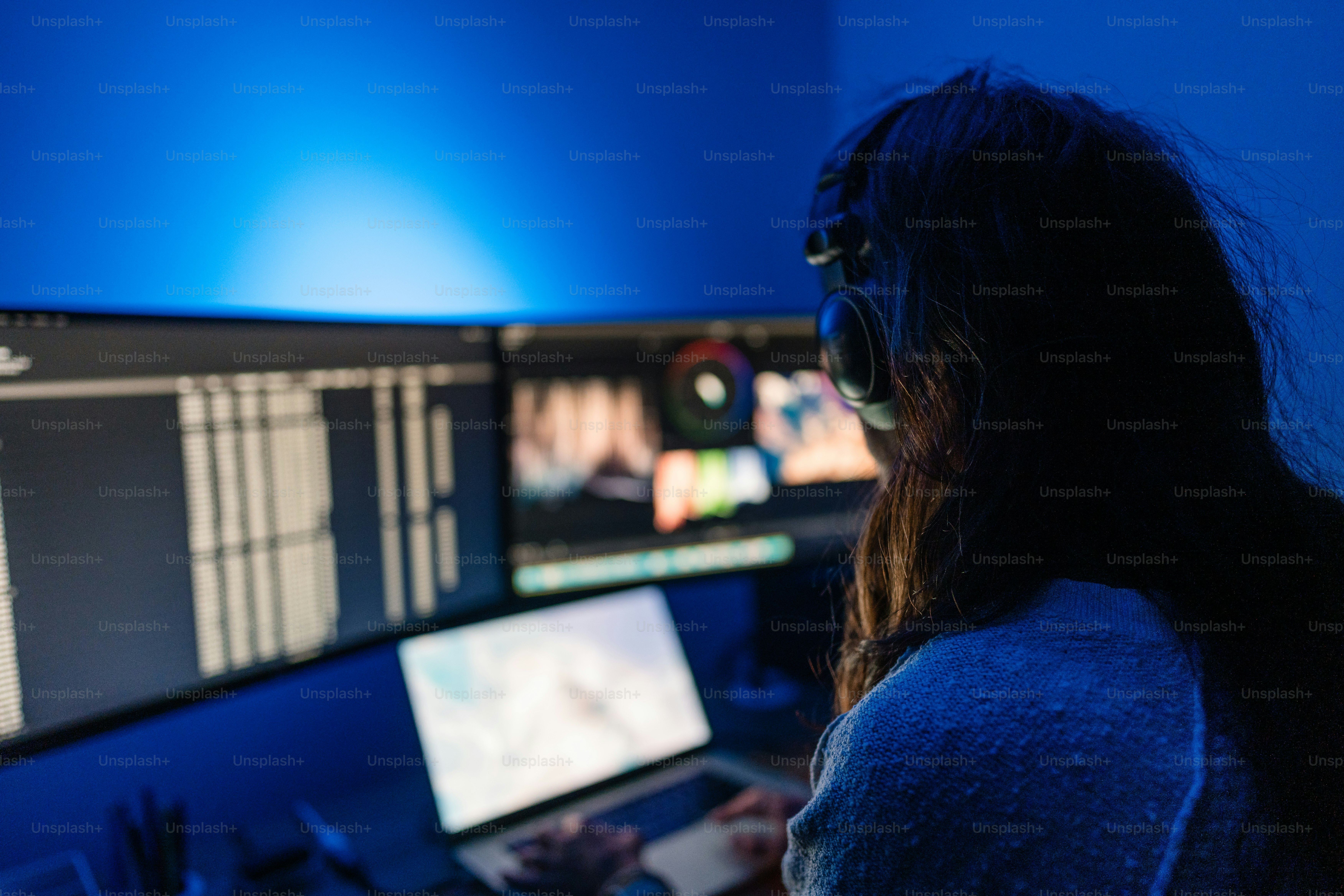A woman sitting in front of a computer monitor
