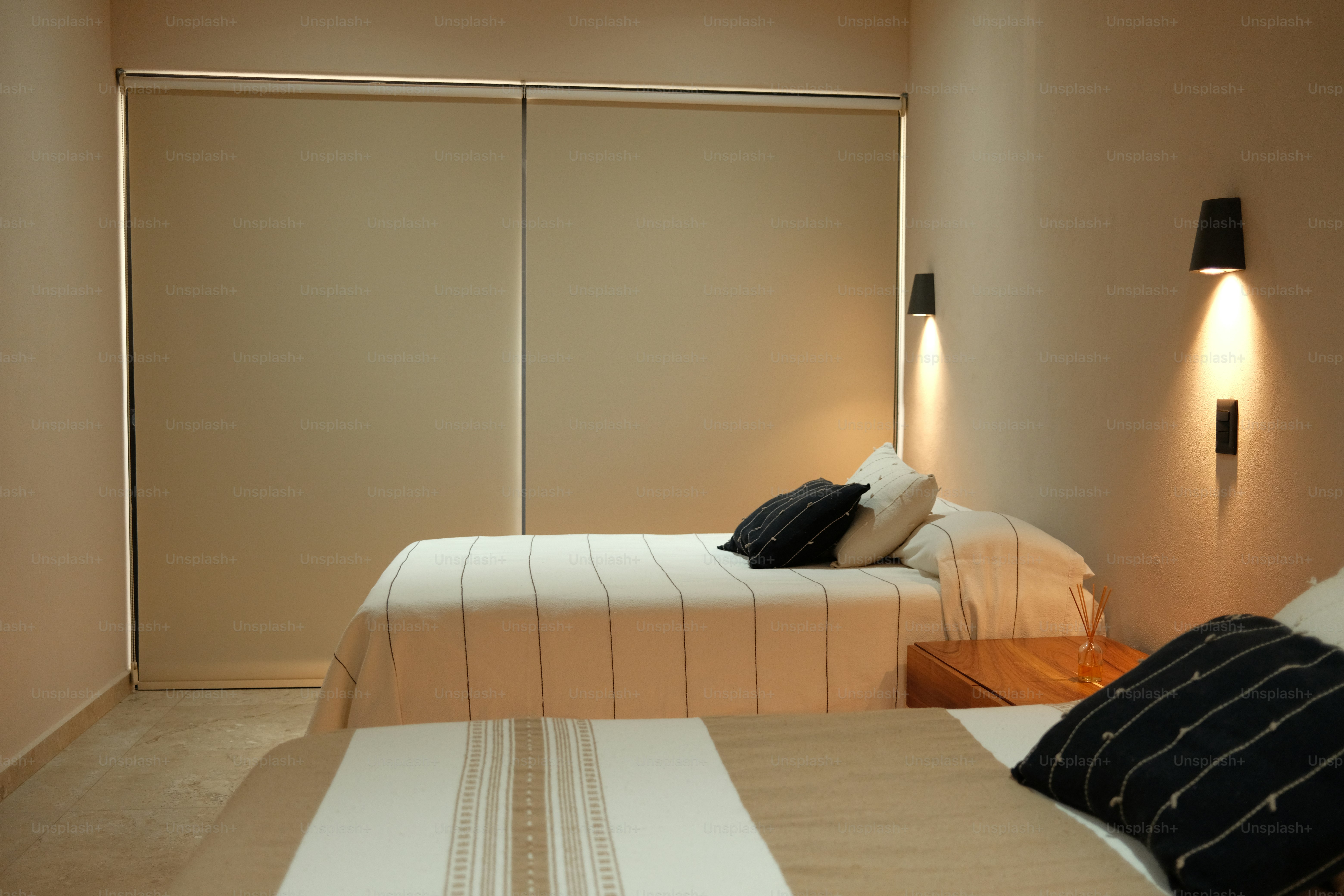 A bedroom with two beds and a closet