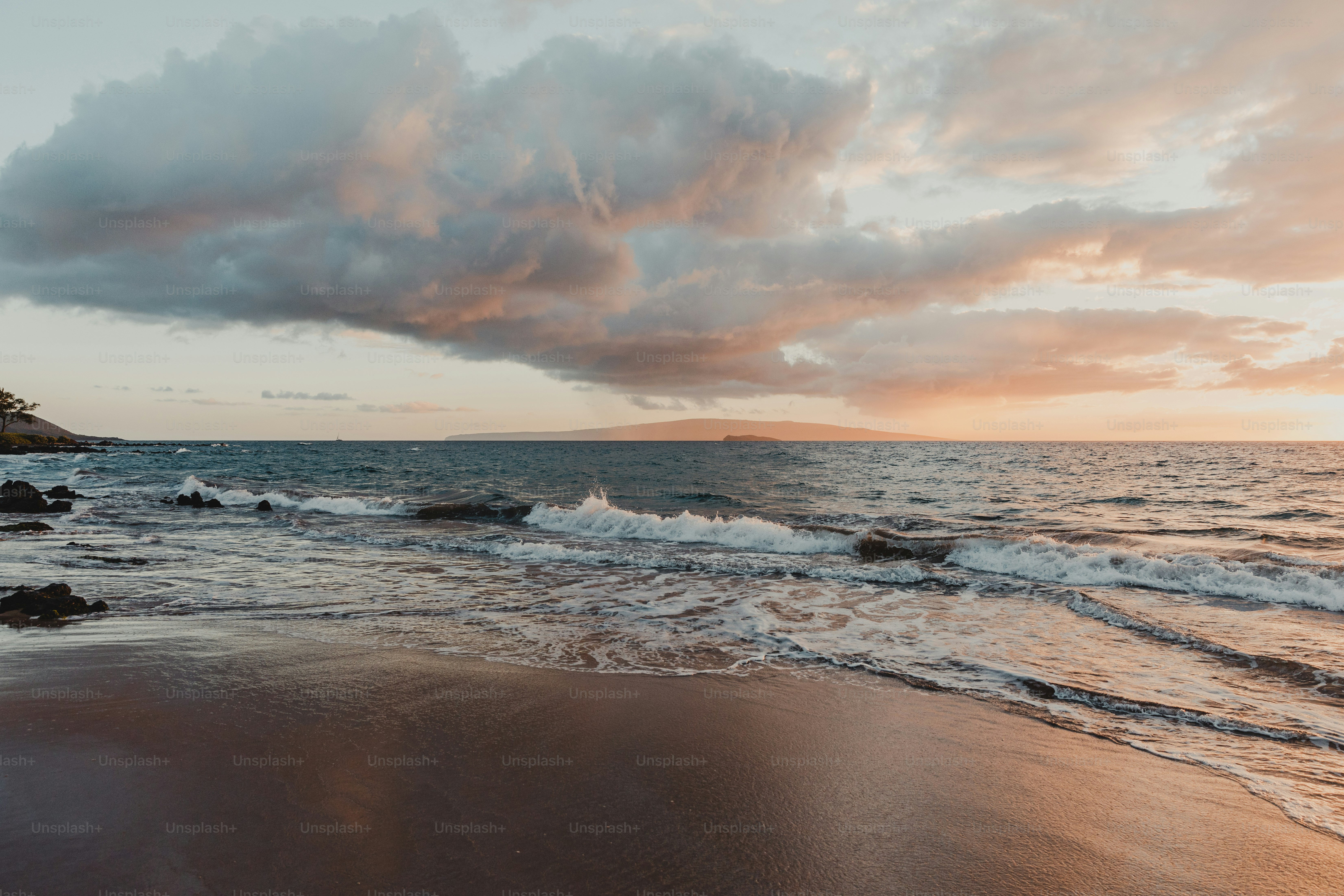 A beach with waves coming in to shore