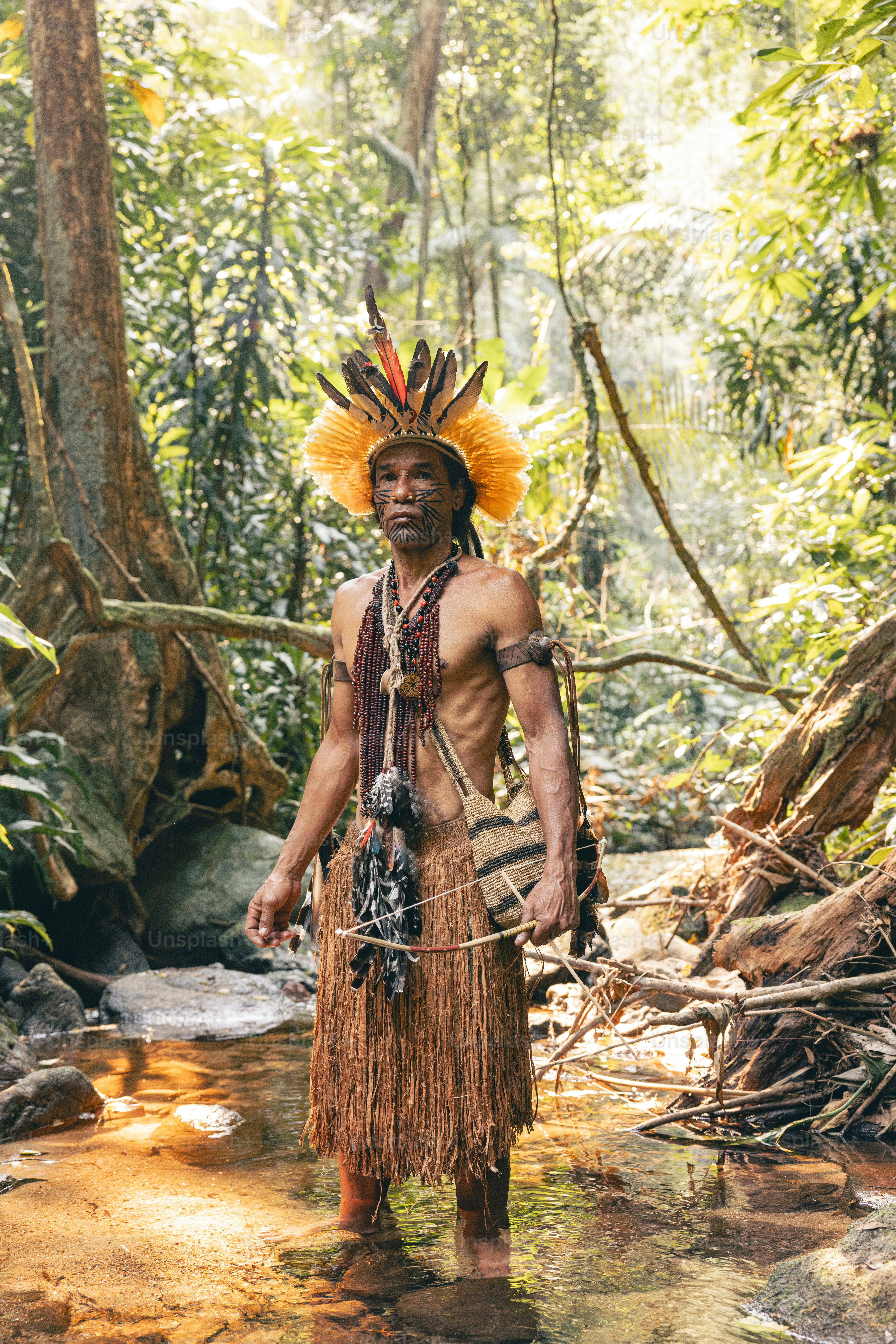A native american man standing in a stream