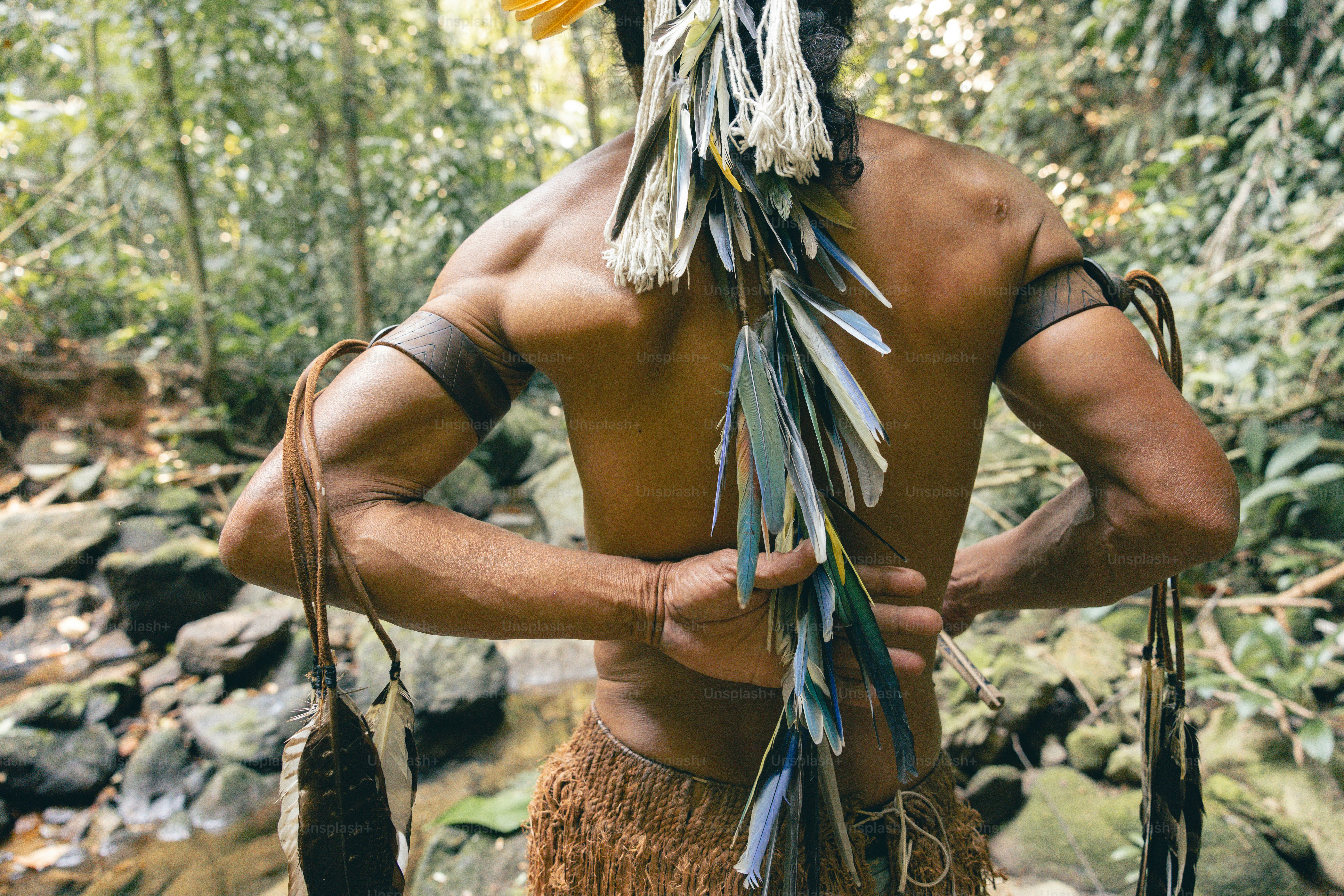 A man in a native american headdress holding a stick