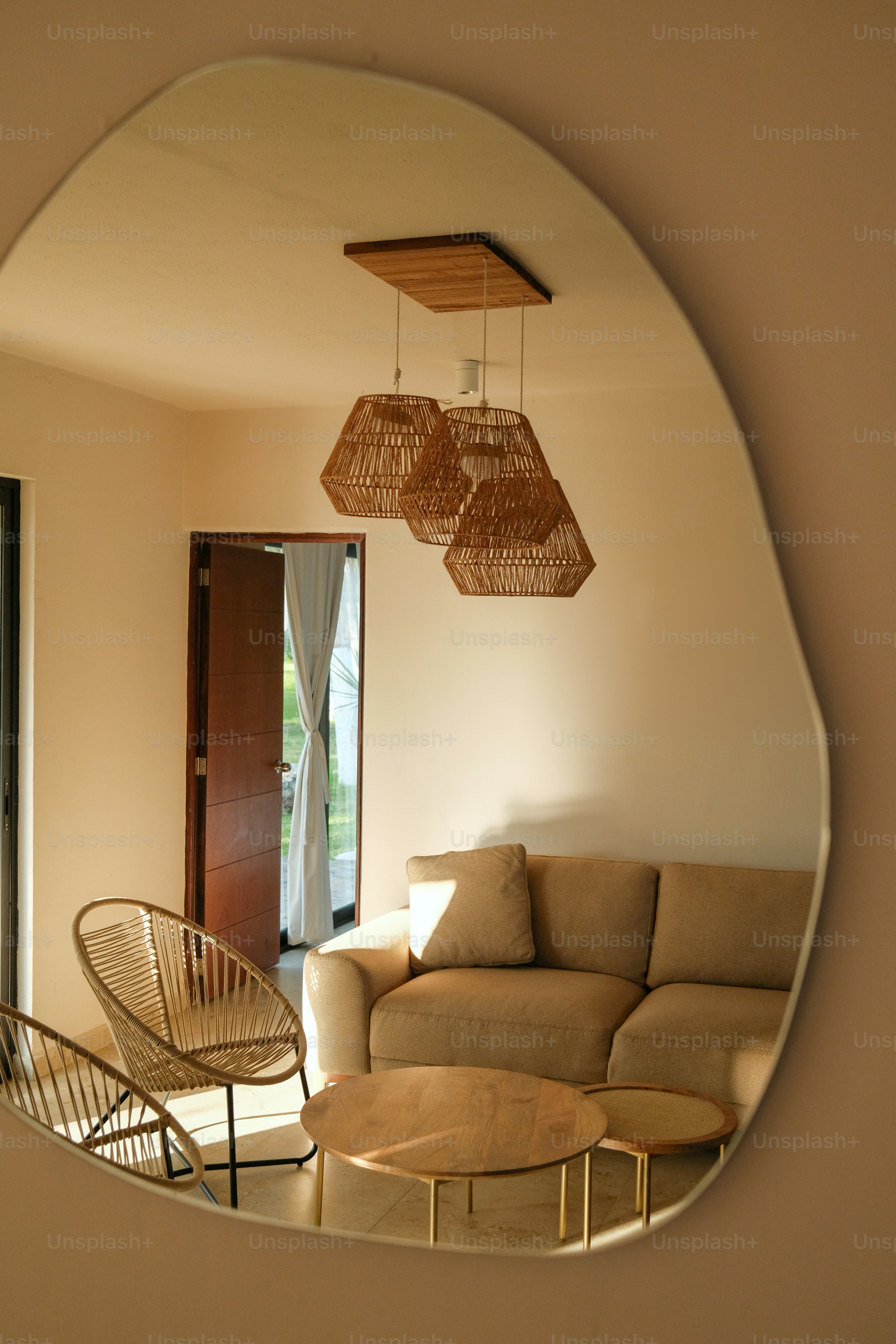 A living room filled with furniture and a large mirror