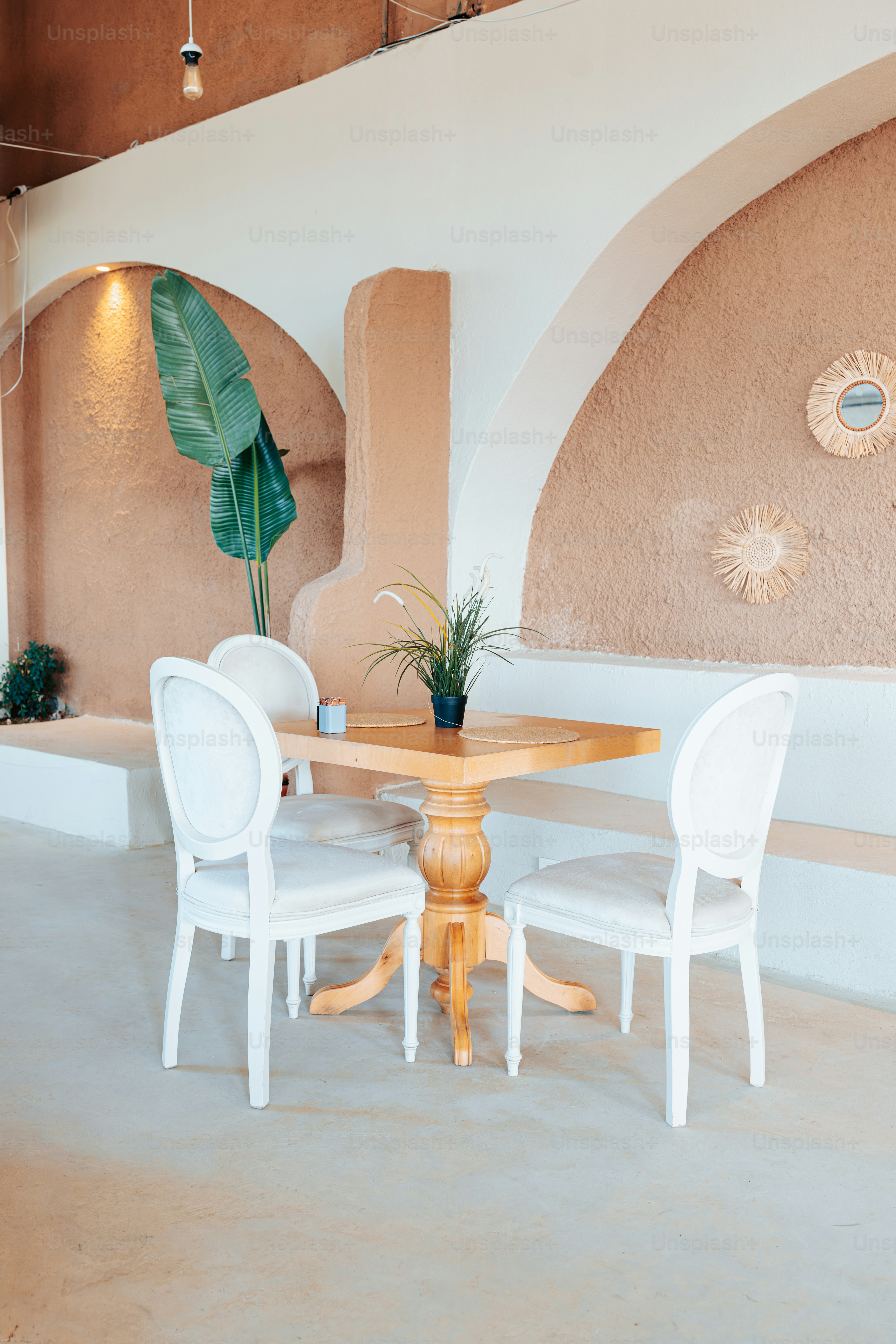 A table and chairs in a room with white walls photo – Texture Image on ...