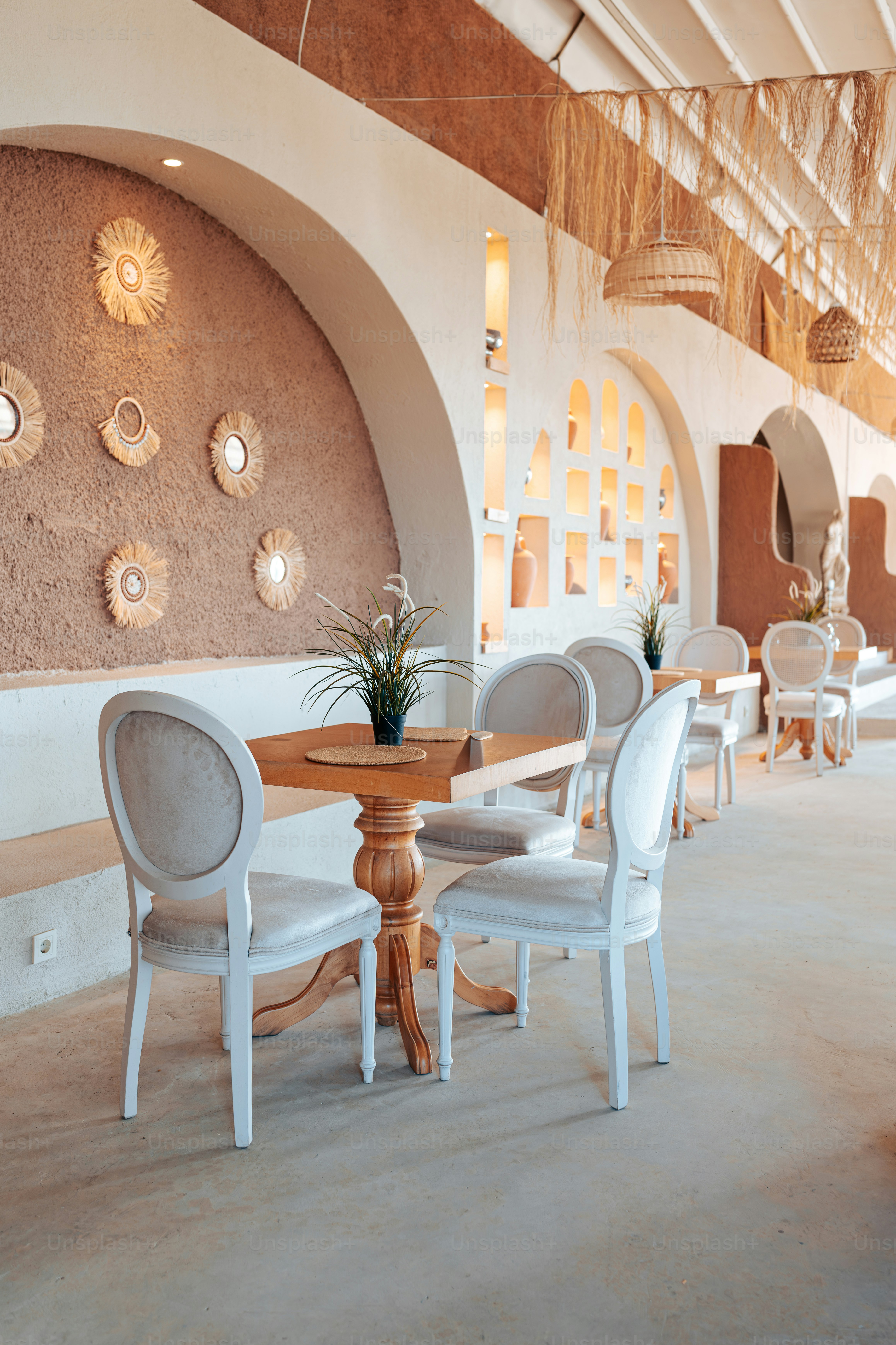 A dining room with white chairs and a wooden table